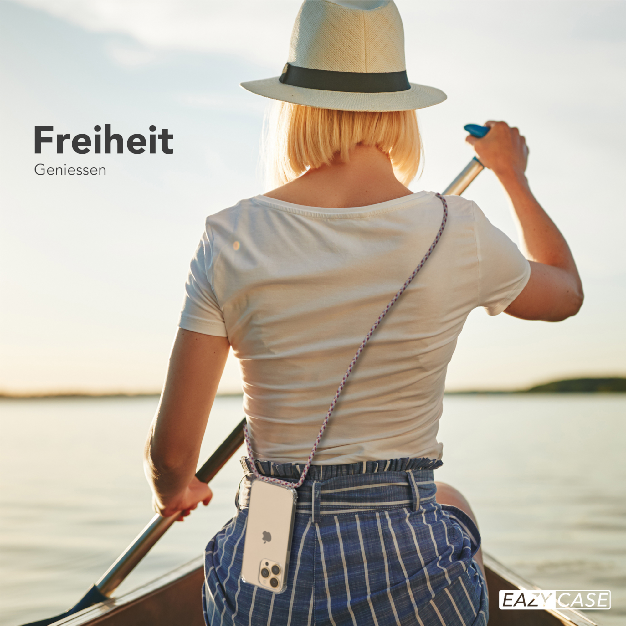 Frau in einem Boot, das auf einem See rudert. Sie trägt einen Hut und ein Telefon mit Lanyard ist sichtbar.