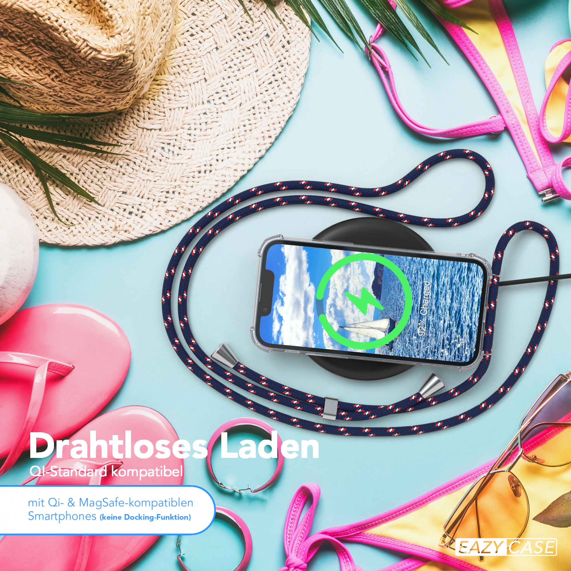 Strandszene mit Telefon, das auf einem kabellosen Pad geladen wird, Sonnenbrille, Flip-Flops und Hut.