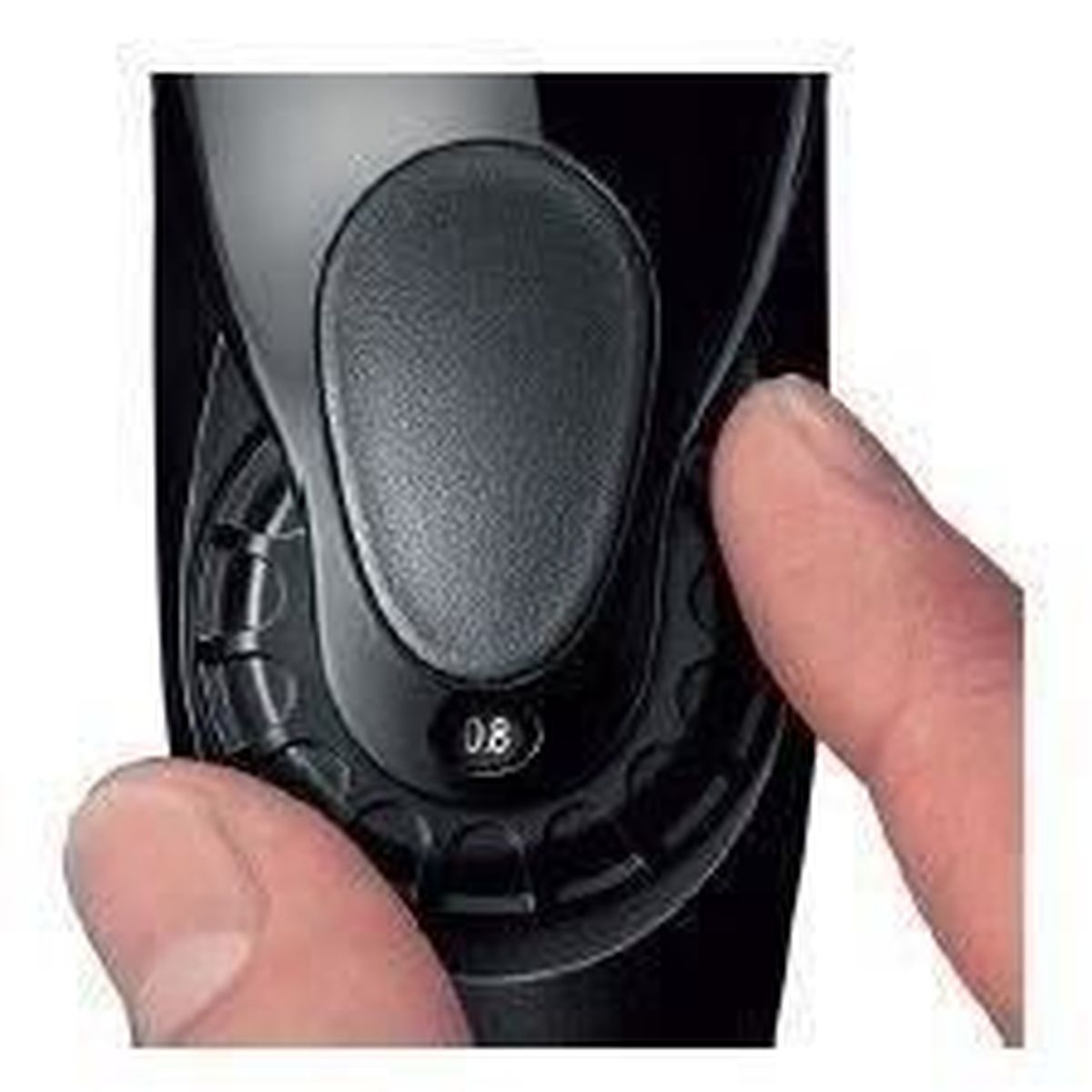Close-up of a black electric shaver with a finger adjusting a setting.