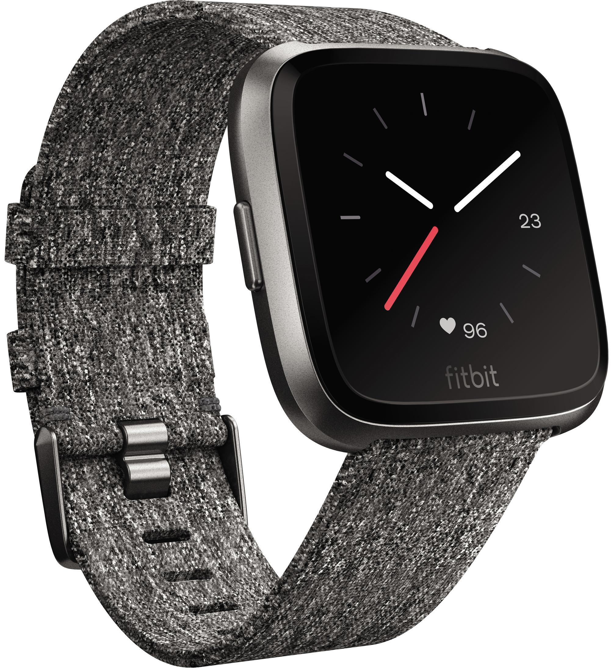 Schwarze Fitbit Smartwatch mit grauem Stoffband. Das Display zeigt Zeit und andere Daten. Fitbit-Logo sichtbar.