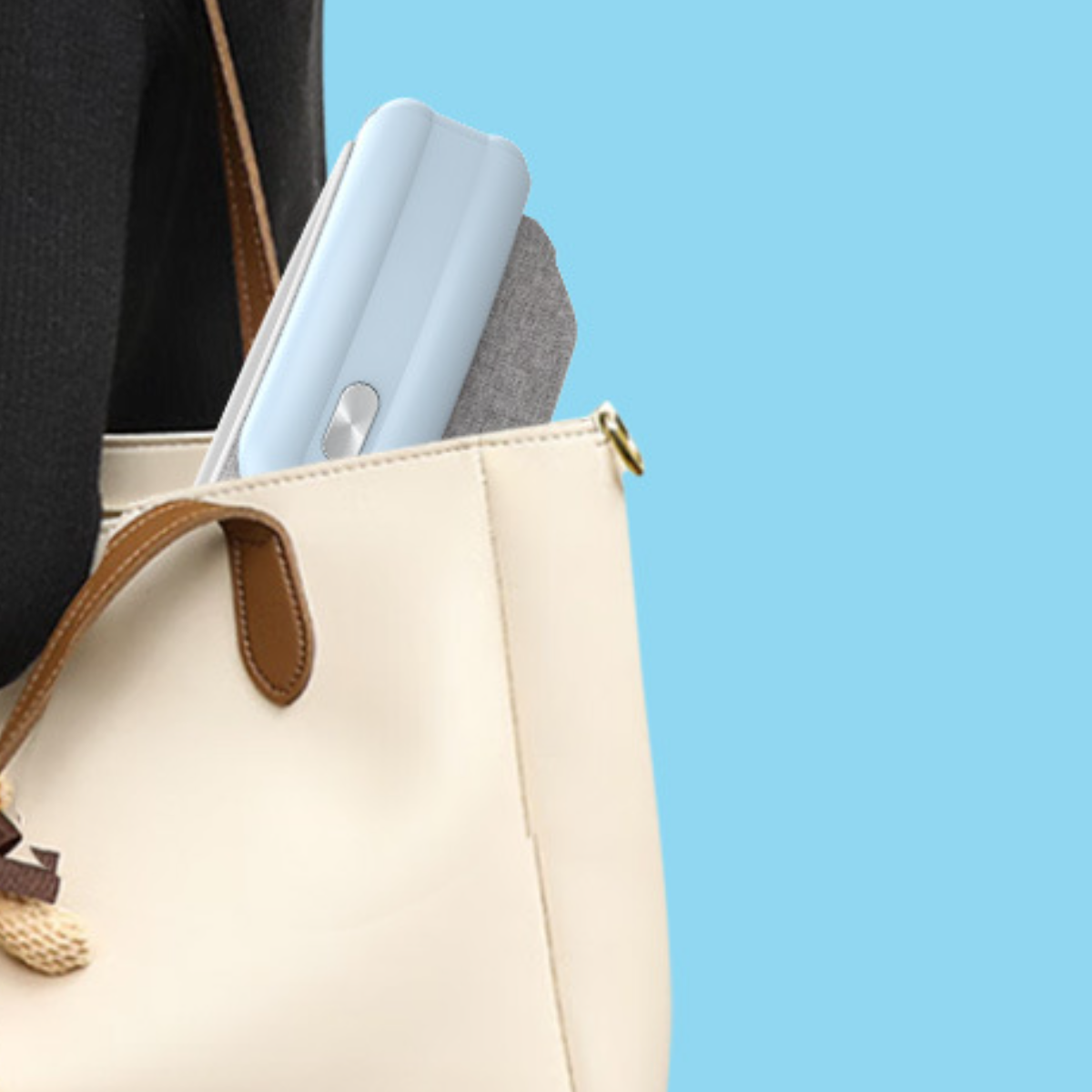 Ein hellblaues Gerät in einer weißen Handtasche. Eine Person hält die Handtasche. Blauer Hintergrund.