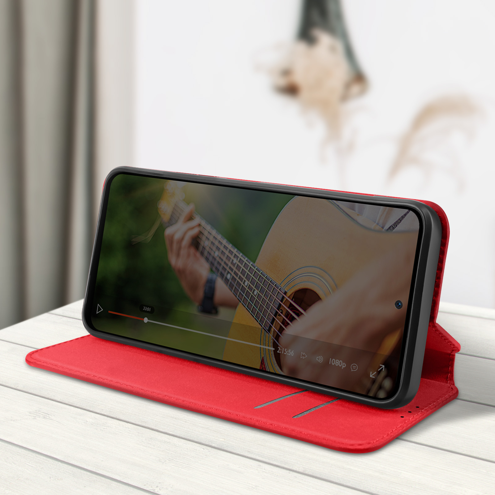 Custodia per telefono rossa con smartphone all'interno, che mostra una persona che suona la chitarra.