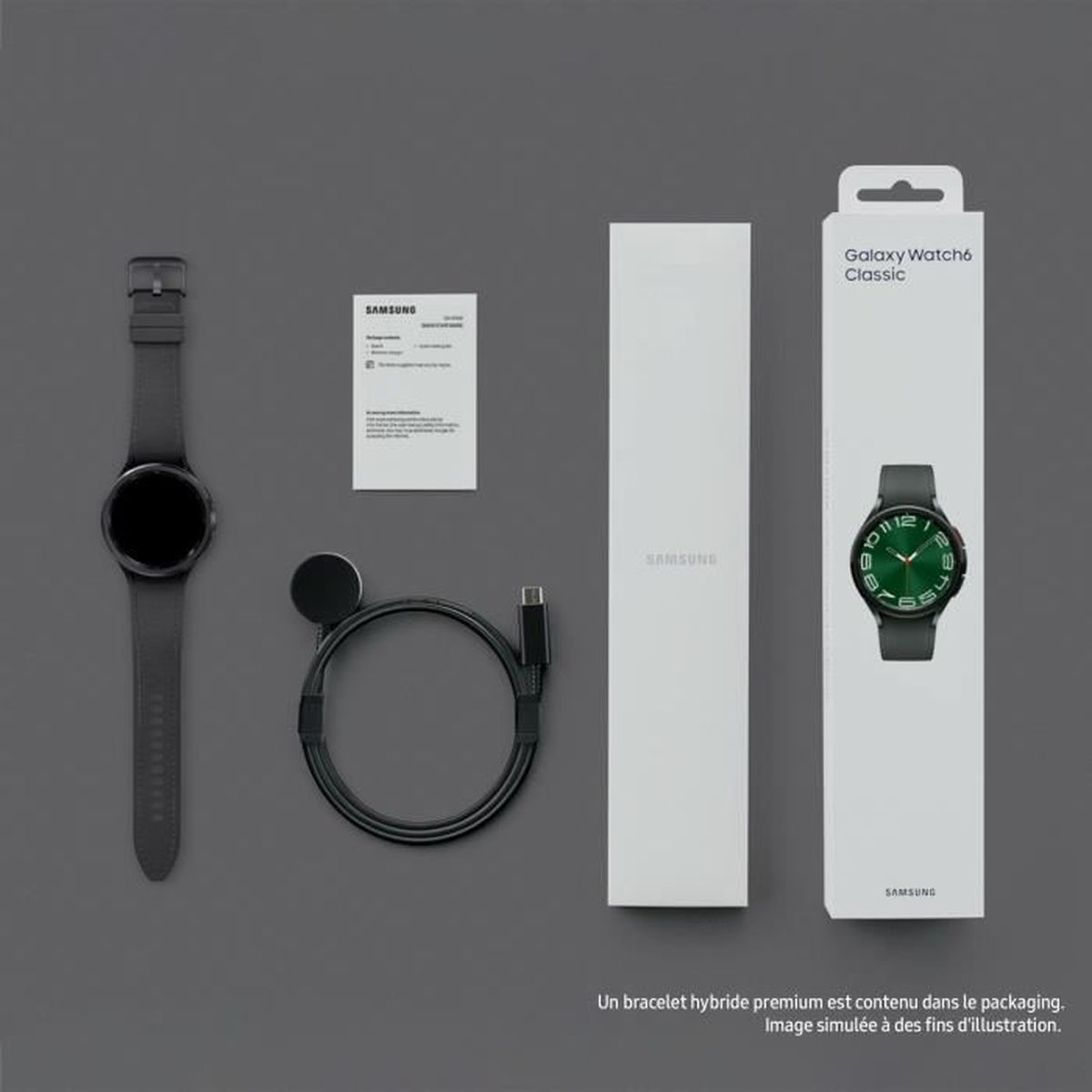 Caja del Samsung Galaxy Watch6 Classic con reloj, cargador, cable y documentación sobre superficie gris.