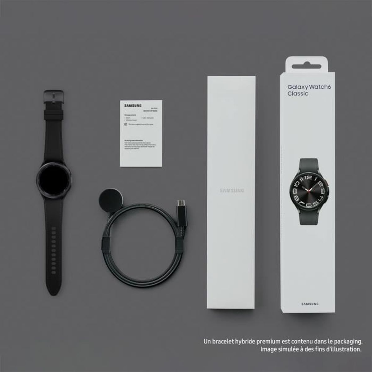 Caja Samsung Galaxy Watch6 Classic con reloj, cargador y documentación, sobre superficie gris oscura.
