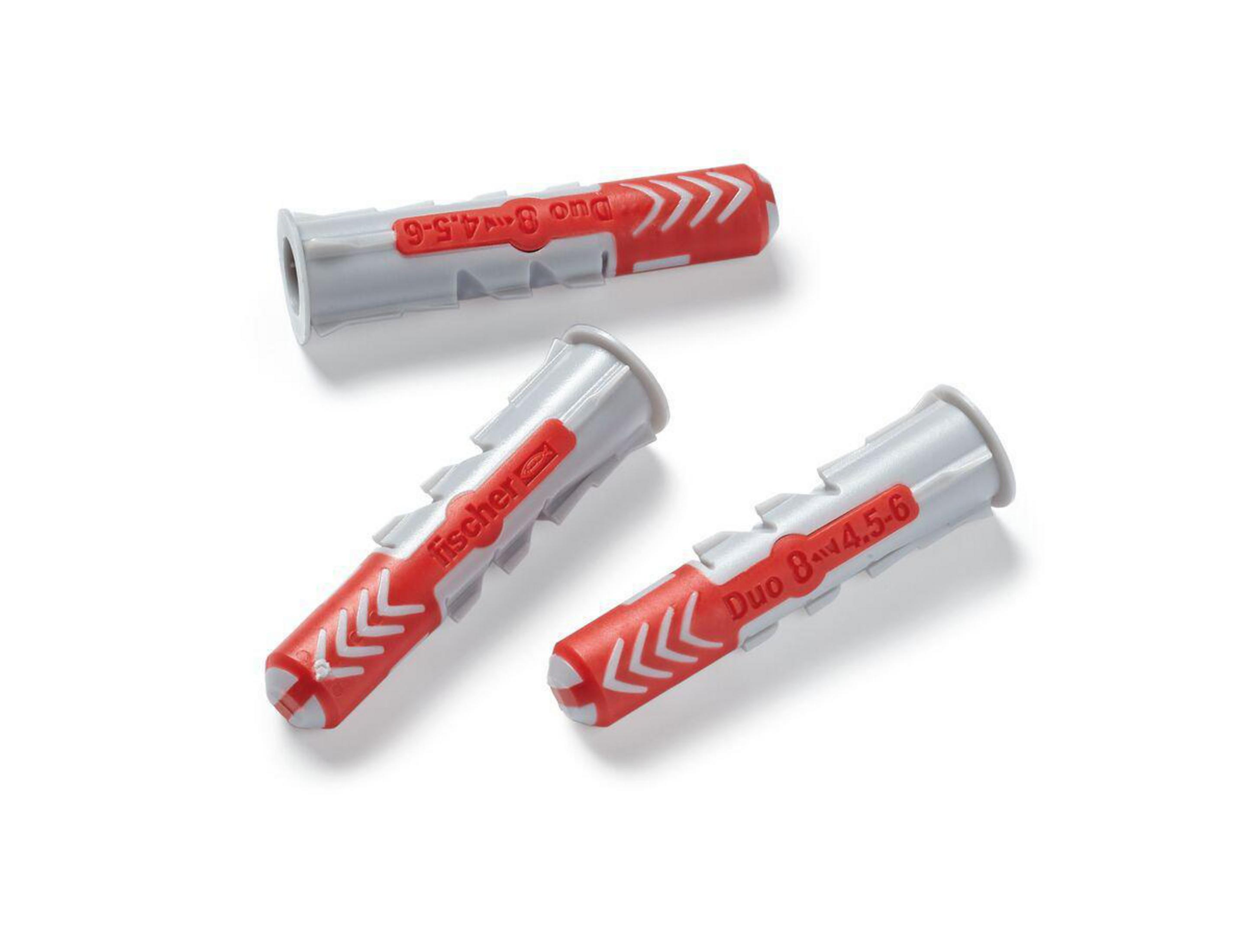 Trzy szare i czerwone kołki rozporowe na białej powierzchni.