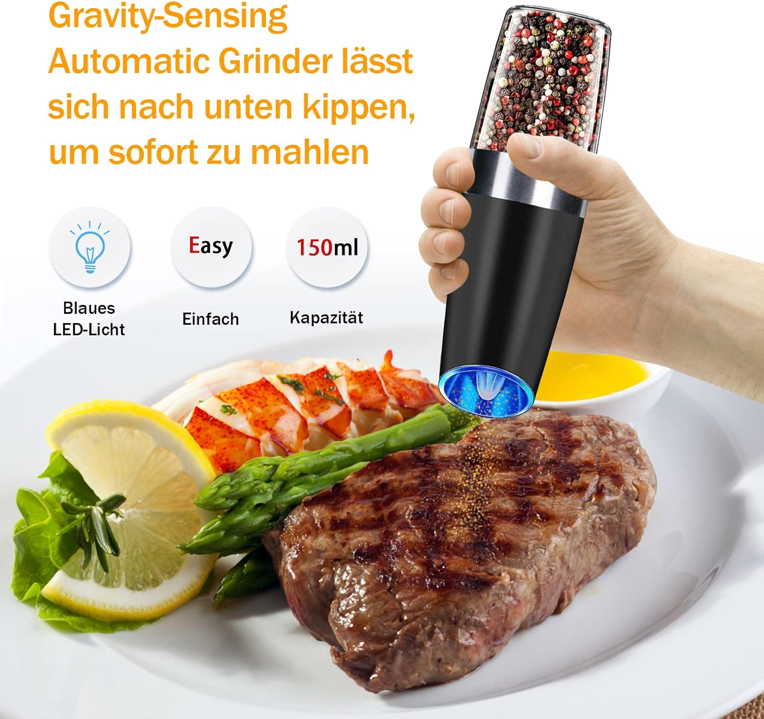 Schwarze elektrische Mühle mit Pfeffer. Steak, Zitrone, Spargel auf einem Teller.