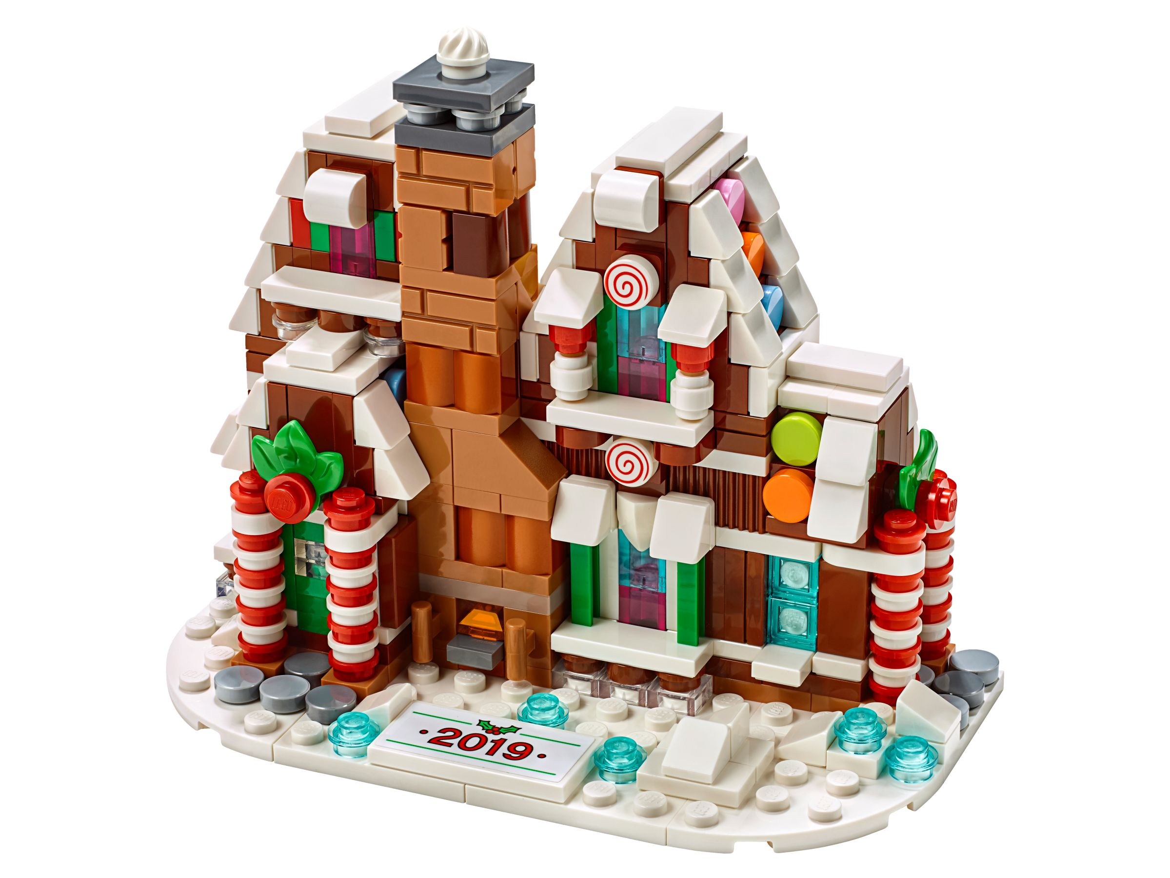 Lego gingerbread house, brown and white with candy details, chimney and snow on a white base.