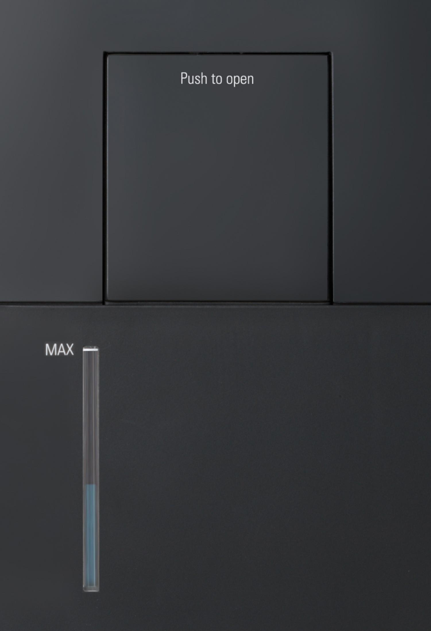 Close-up of a black, rectangular control panel with the words "Push to open" and a liquid level indicator.
