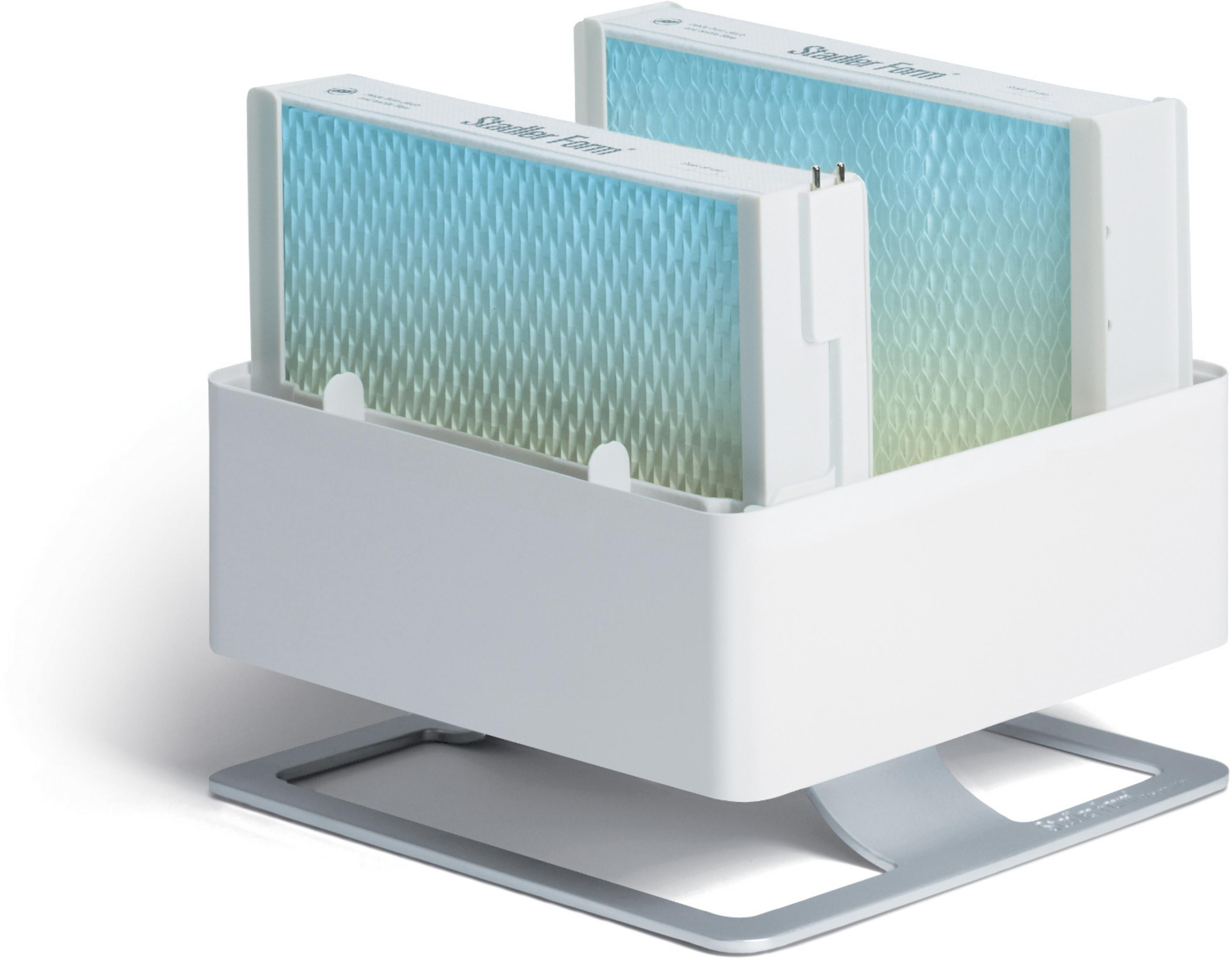Two humidifier filters inside a white holder on a silver base. White background.