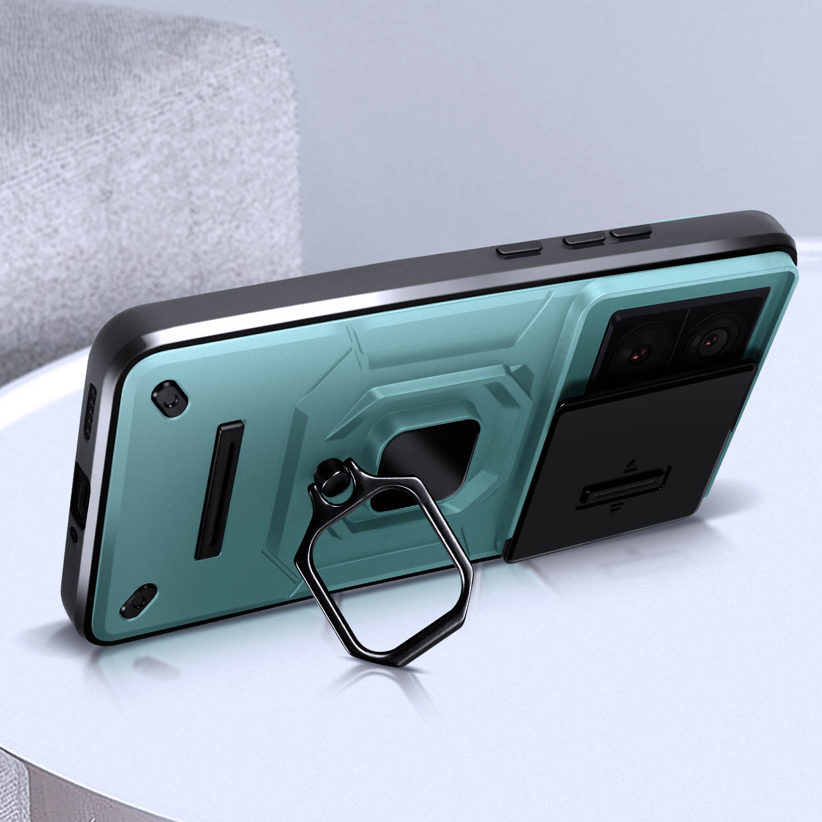 Custodia per telefono con anello di supporto. La custodia ha un retro verde acqua e dettagli neri.