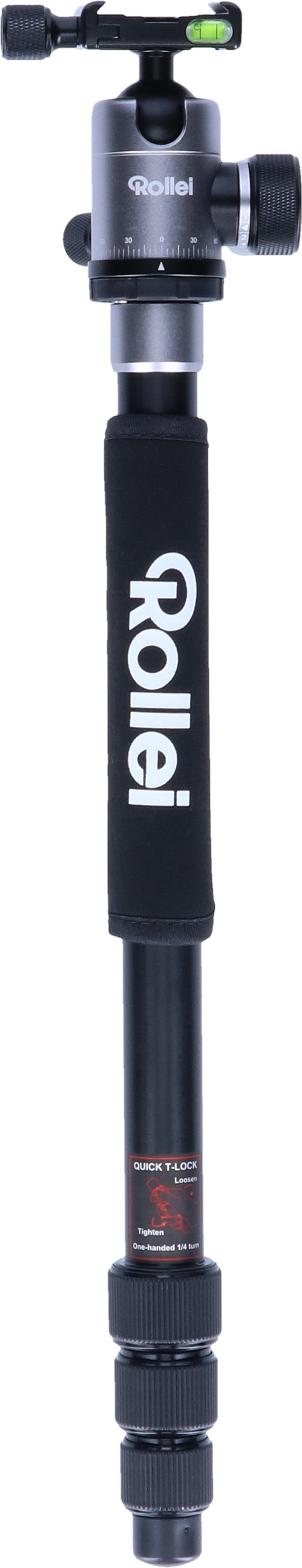 Statyw z czarnym uchwytem i srebrną głowicą. Stoi pionowo.