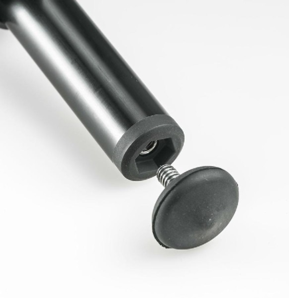 Schwarzes Metallbein mit Gummifuß und Feder, weißer Hintergrund.