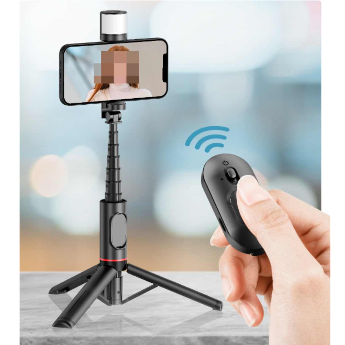Smartphone auf einem Stativ mit Fernbedienung. Verschwommener Hintergrund. Der Bildschirm ist sichtbar.