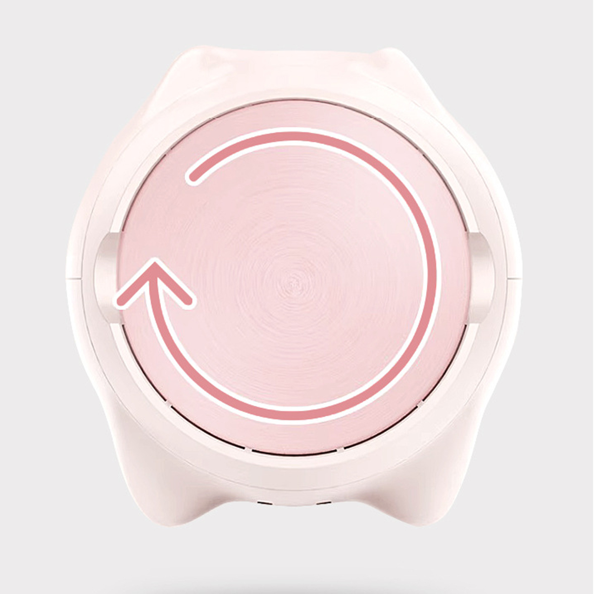 Ein rosa-weißes Gerät mit kreisförmigem Design und Pfeilindikator.