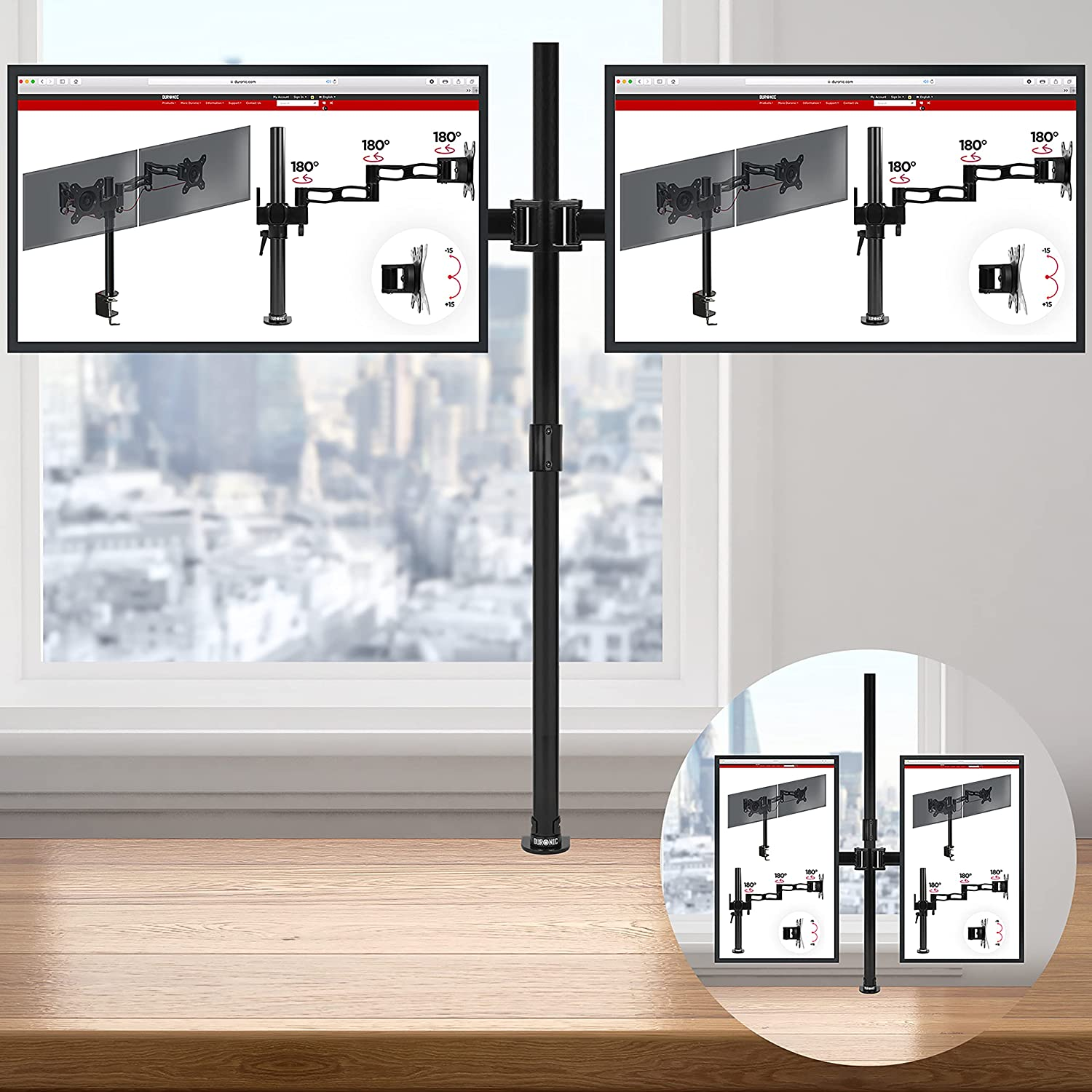 Zwei Monitore auf einem schwarzen Ständer, auf einem Holzschreibtisch am Fenster.