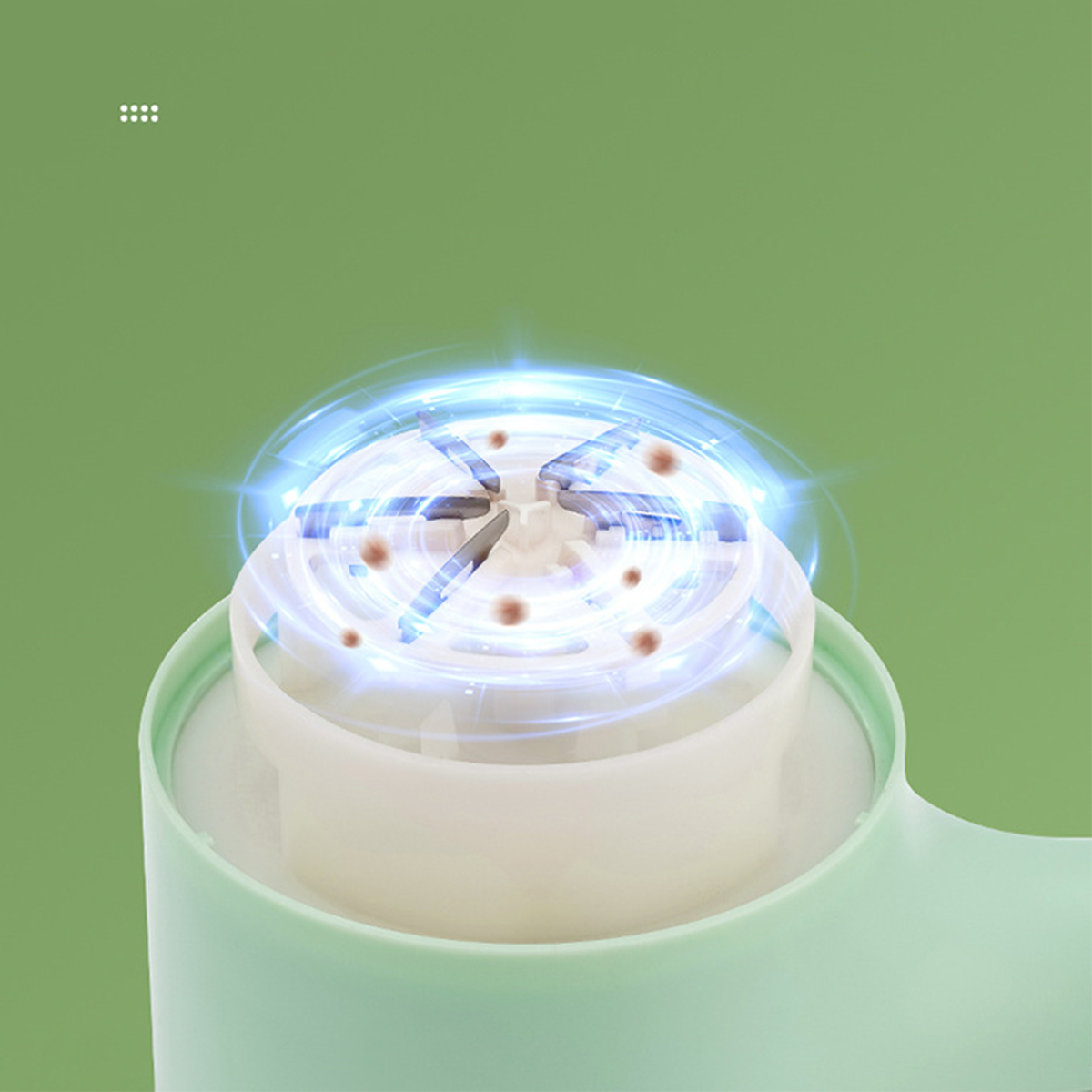 Nahaufnahme eines weißen und hellgrünen Geräts mit einem sich drehenden Innenmechanismus, der Licht emittiert.