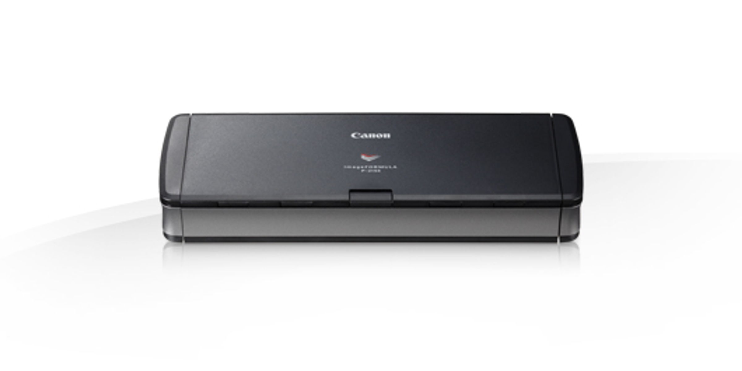 Scanner Canon, nero, rettangolare, su superficie bianca.