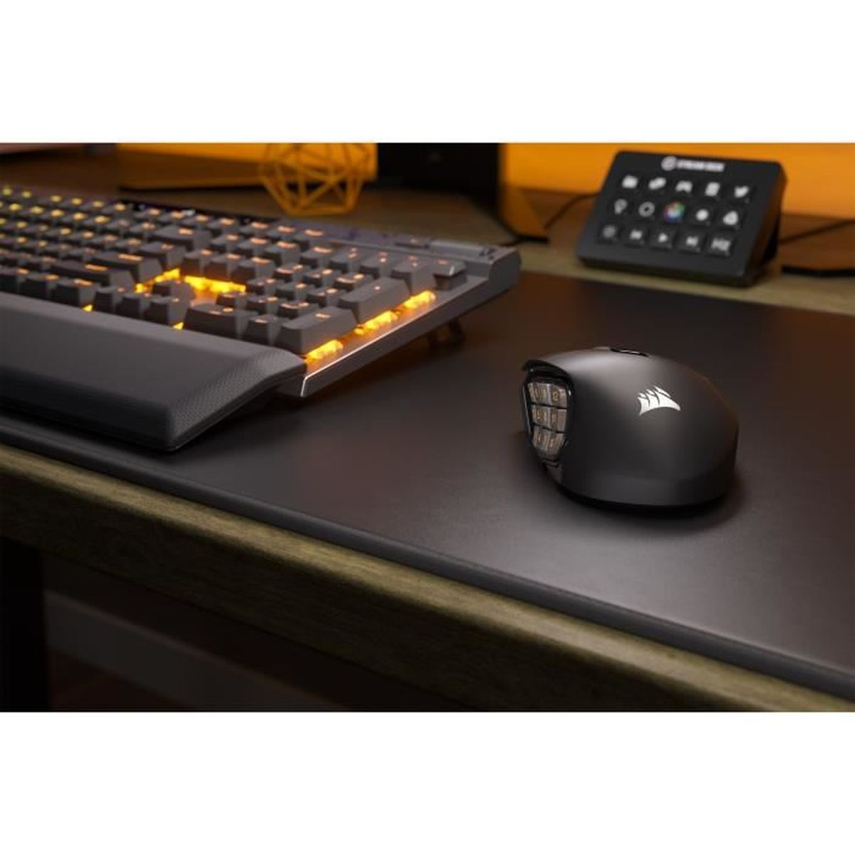 A gaming setup with a black mouse and keyboard. The keyboard has orange lights.