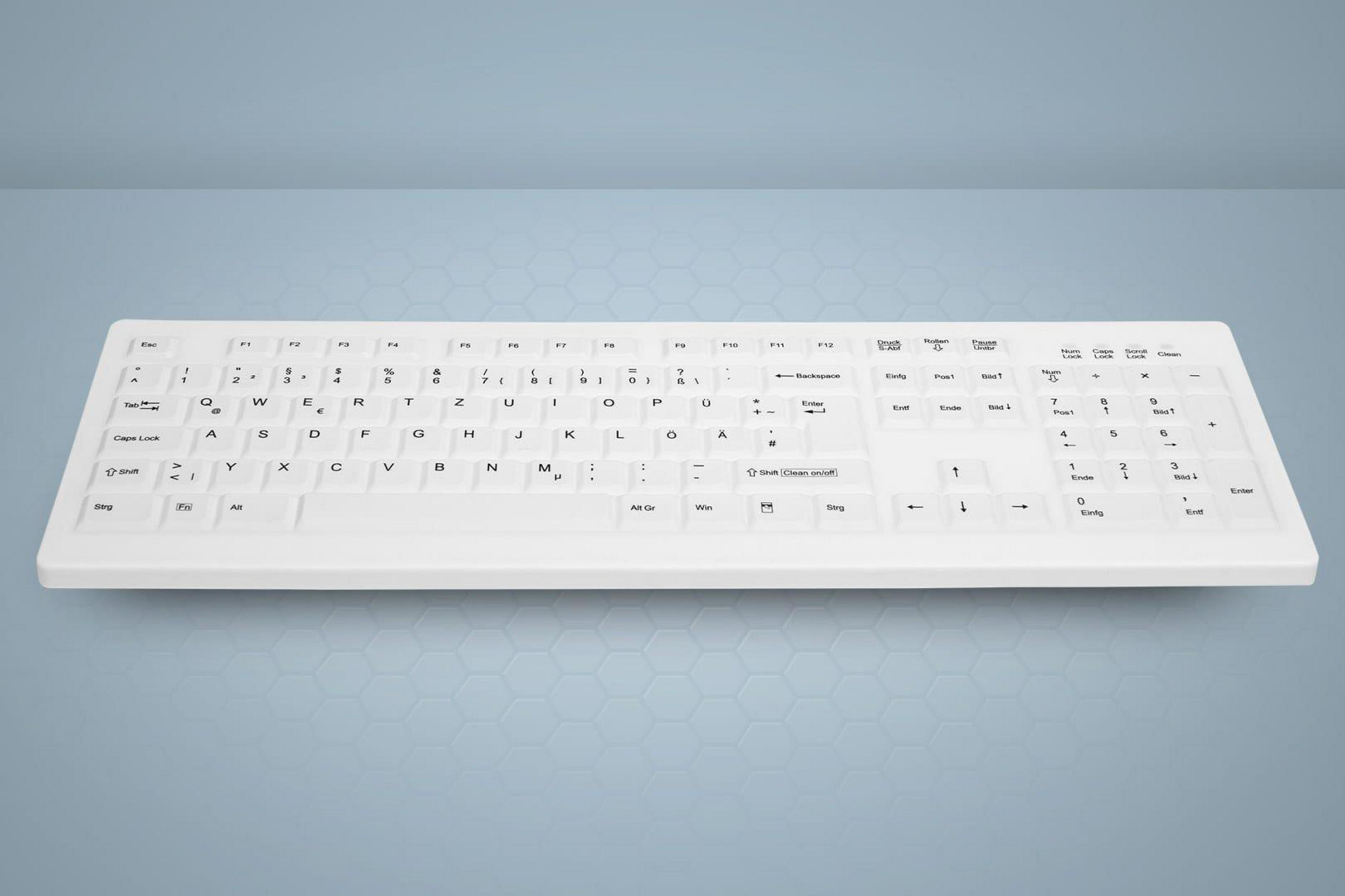 Weiße Tastatur auf blauem Hintergrund mit weißen Tasten. Die Tasten haben Buchstaben und Symbole.