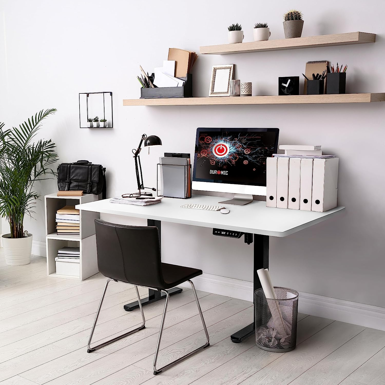 Moderne Büroausstattung mit Computer, Schreibtisch, Stuhl und Pflanzen.