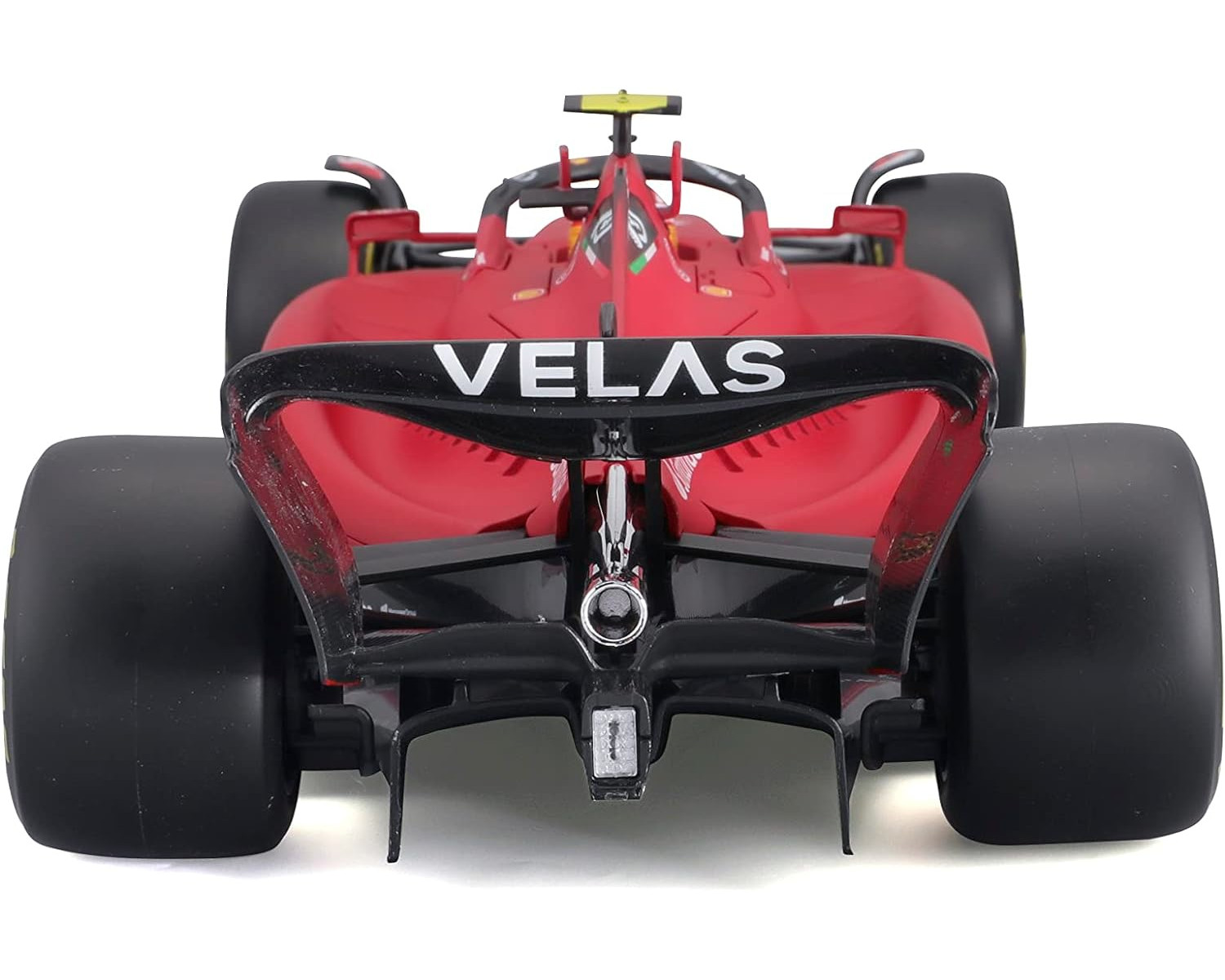 Ein roter Ferrari Formel 1 Wagen, Rückansicht, mit dem Wort VELAS hinten.
