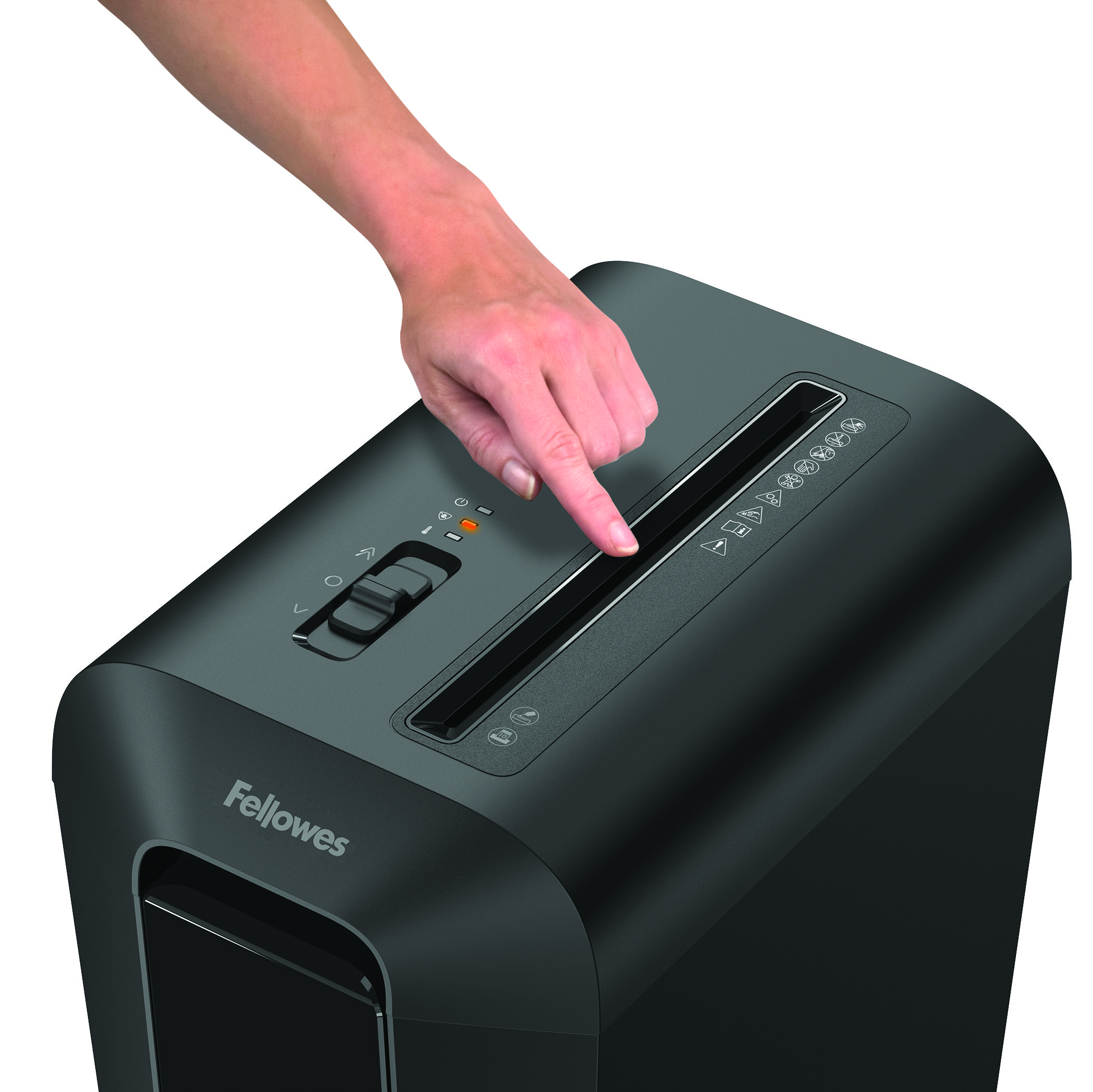 Une main appuyant sur un bouton d'une déchiqueteuse Fellowes noire. Montre une fente.