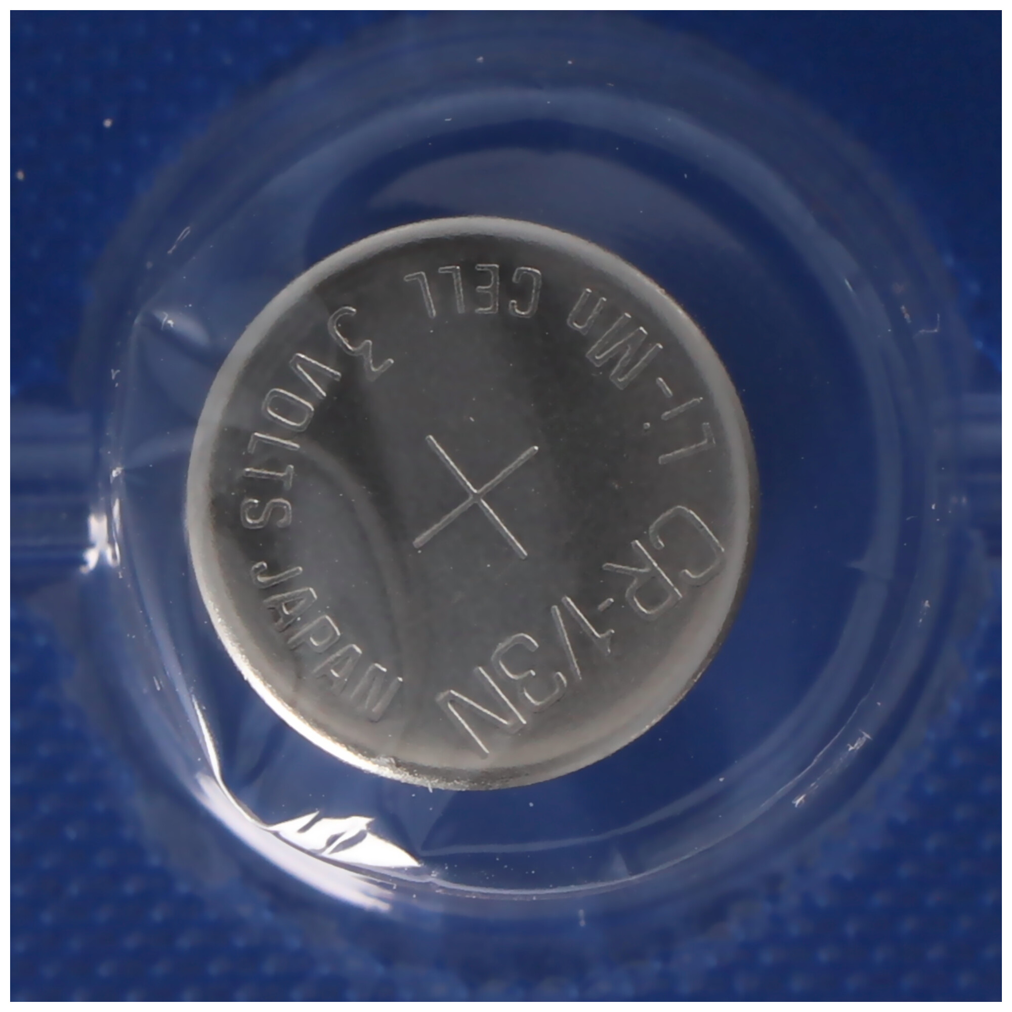 A CR-1/3N 3 volt battery, surrounded by plastic. Text on battery reads: 3 Volts Japan CR-1/3N