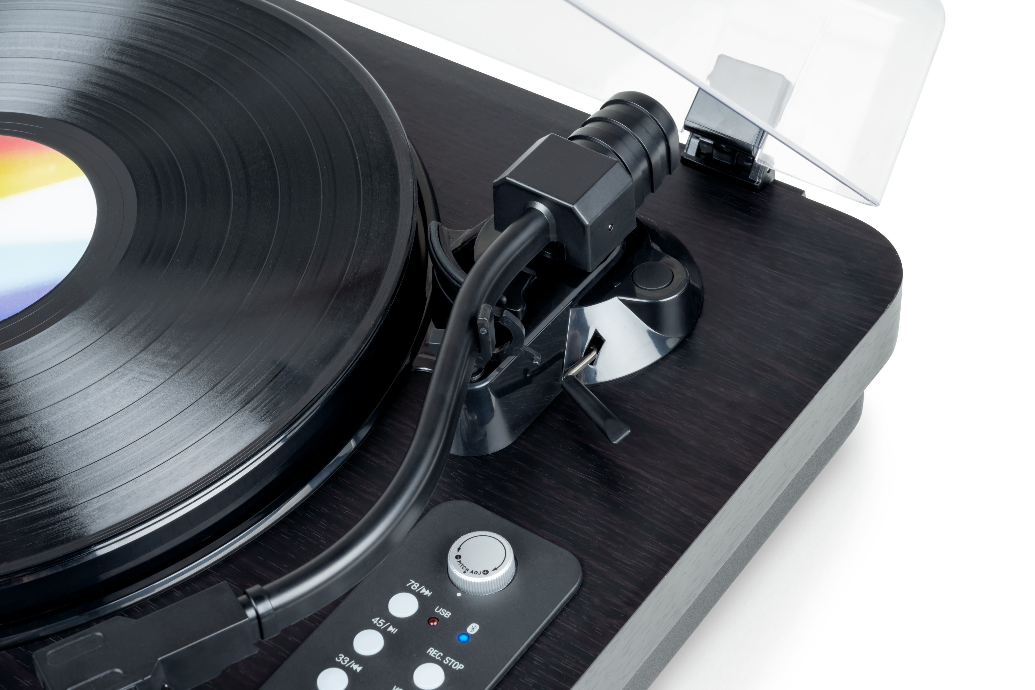 Zbliżenie gramofonu z płytą winylową i ciemnym drewnianym wykończeniem.