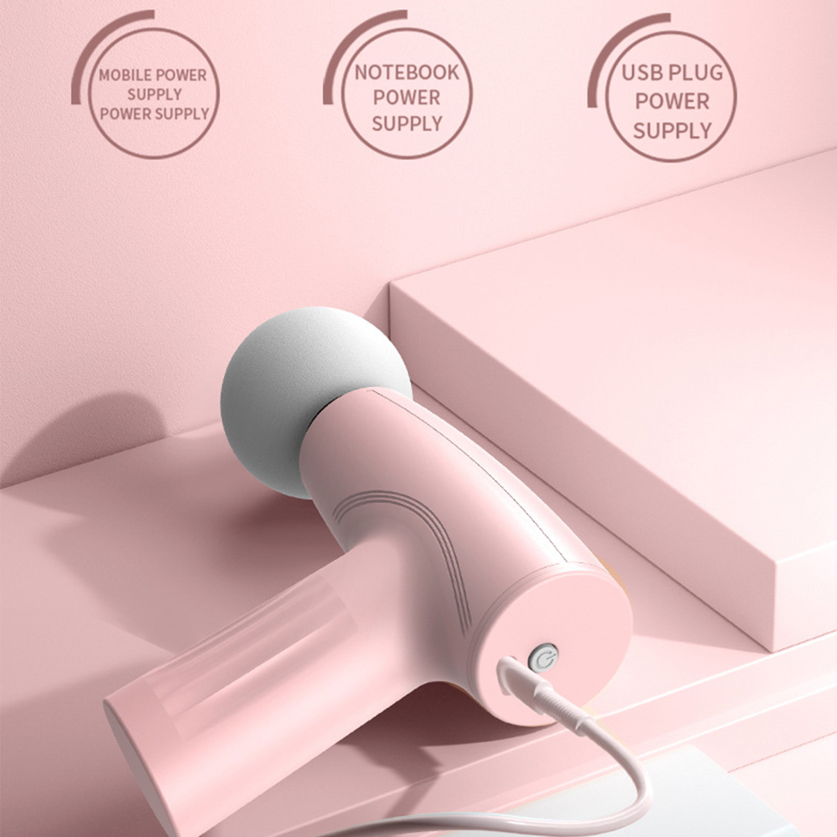 Ein rosa Handgerät mit einem weißen kugelförmigen Kopf und drei Etiketten: mobil, Notebook und USB-Stromversorgung.