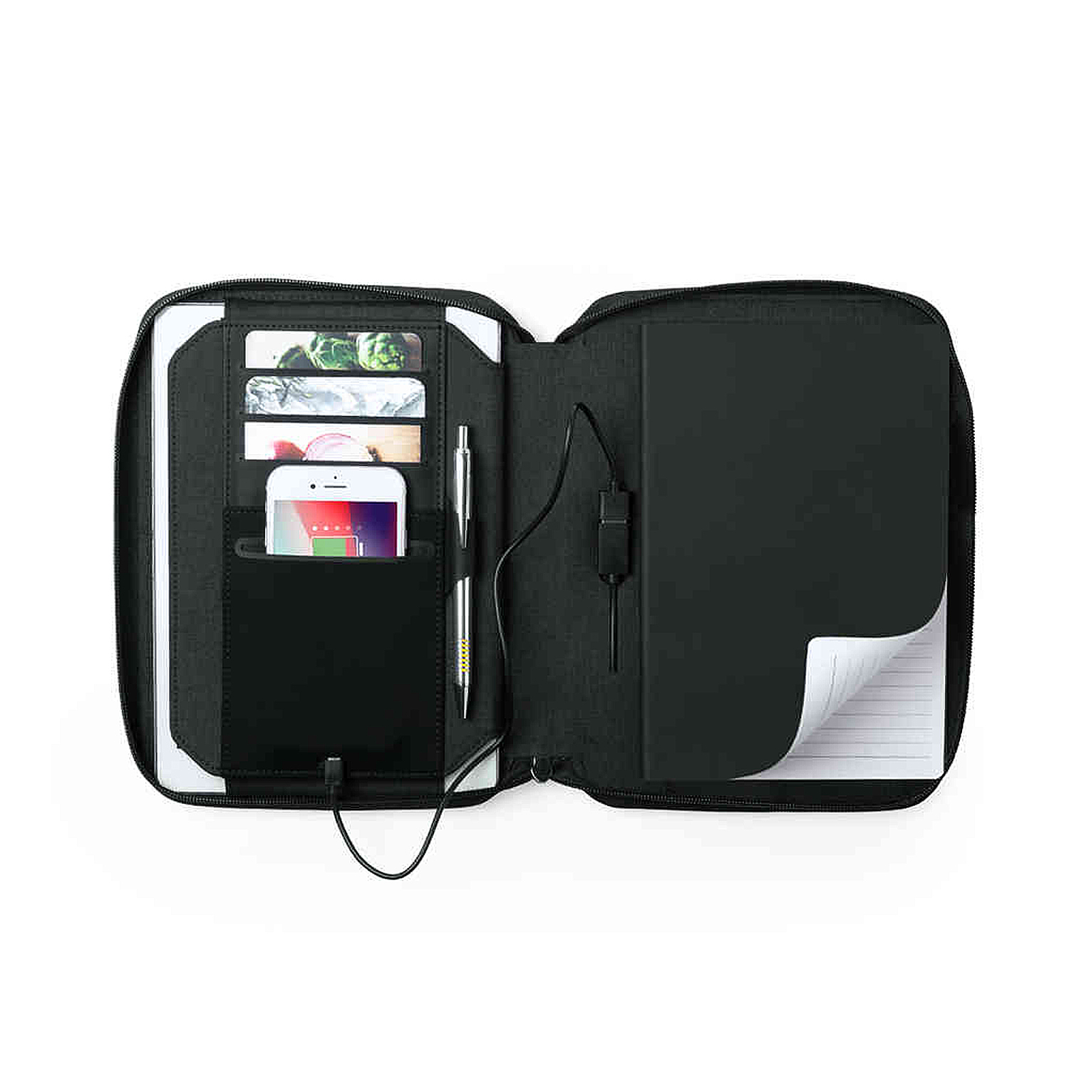 Portafolio negro abierto con teléfono, tarjetas, bolígrafo y cuaderno. Cable de carga presente.