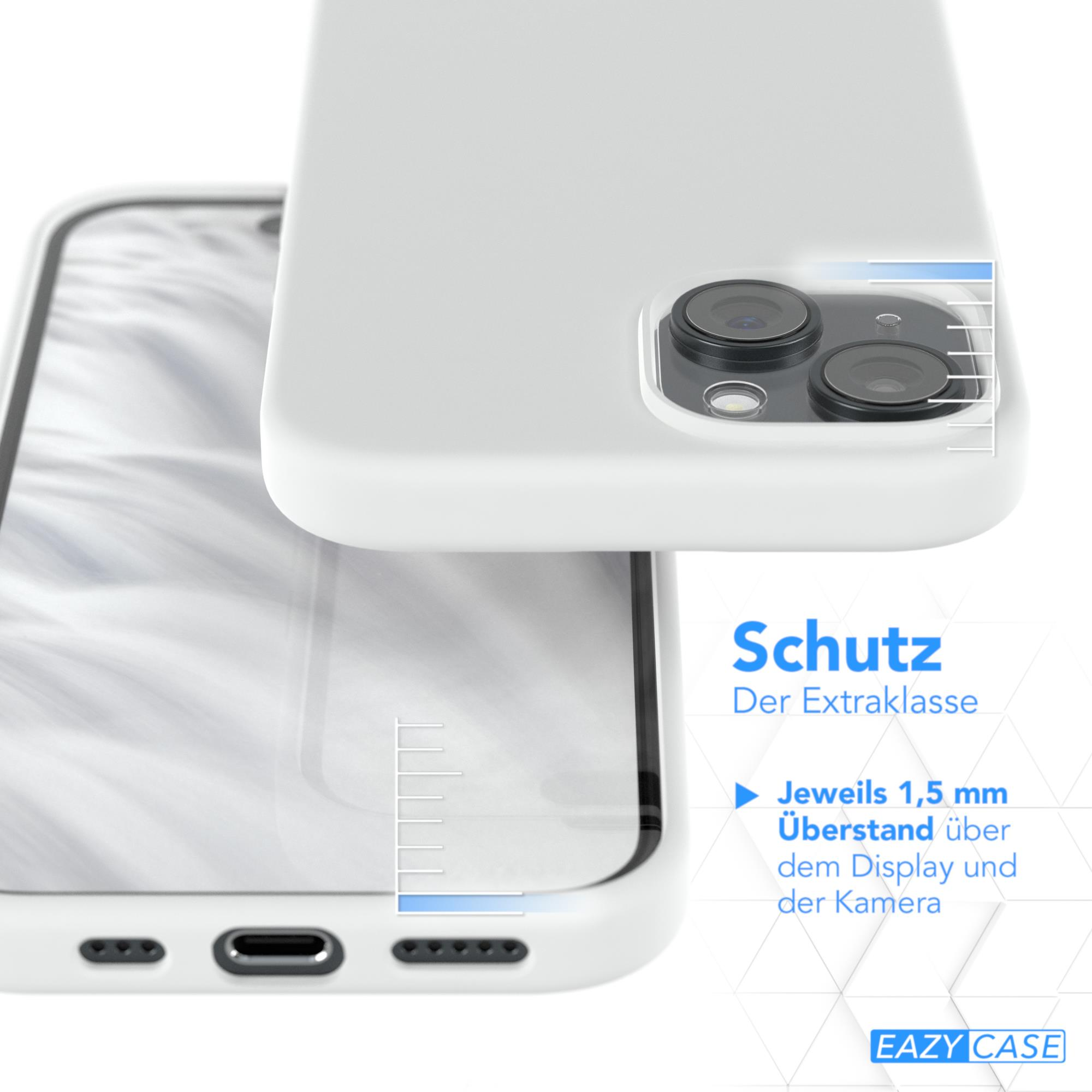 Ein Telefon, das drahtlos auf einem Ladepad geladen wird, neben einer Kaffeetasse und Blumen.