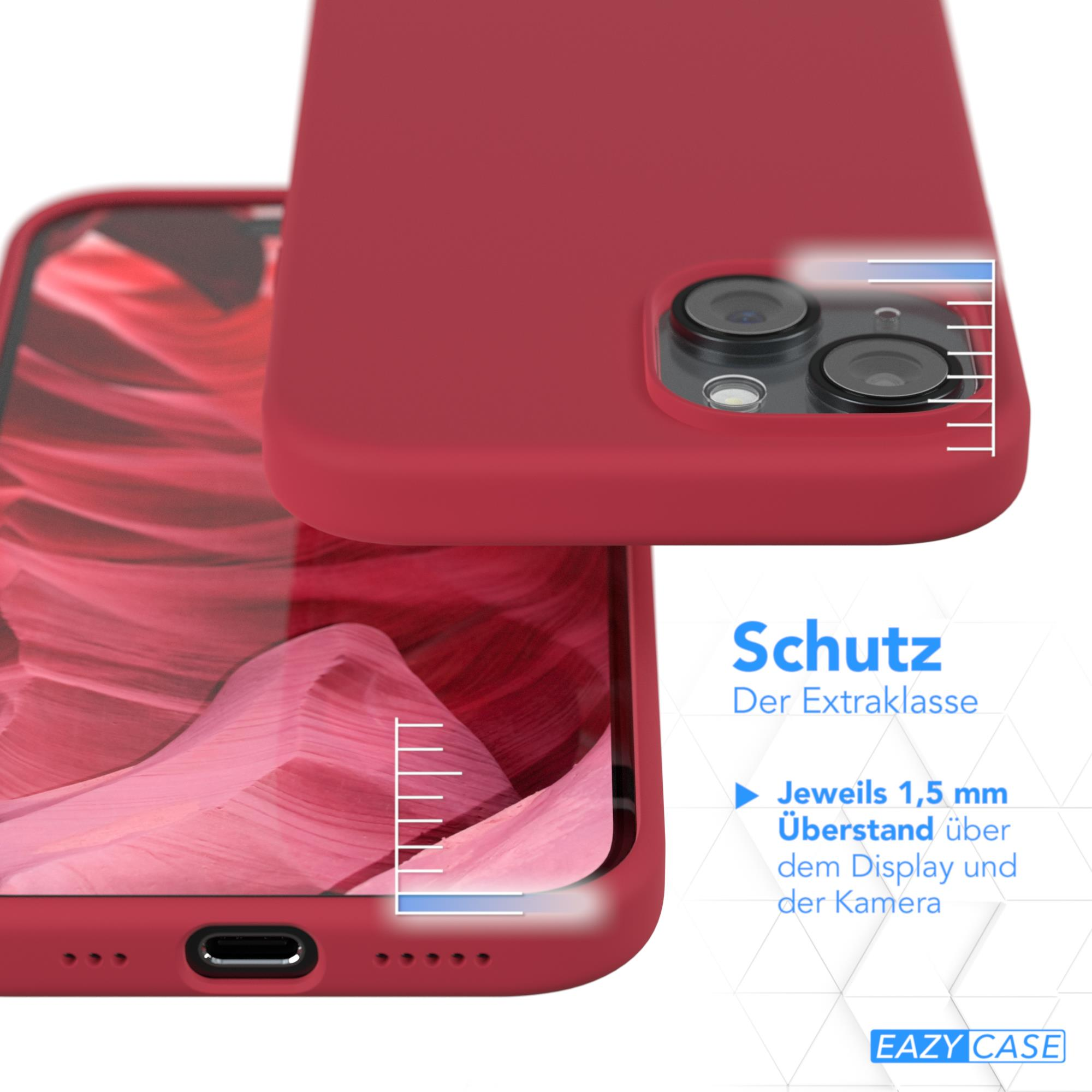 Rote Handyhülle neben einem Telefon. Eine weiße Messskala befindet sich an der Seite.