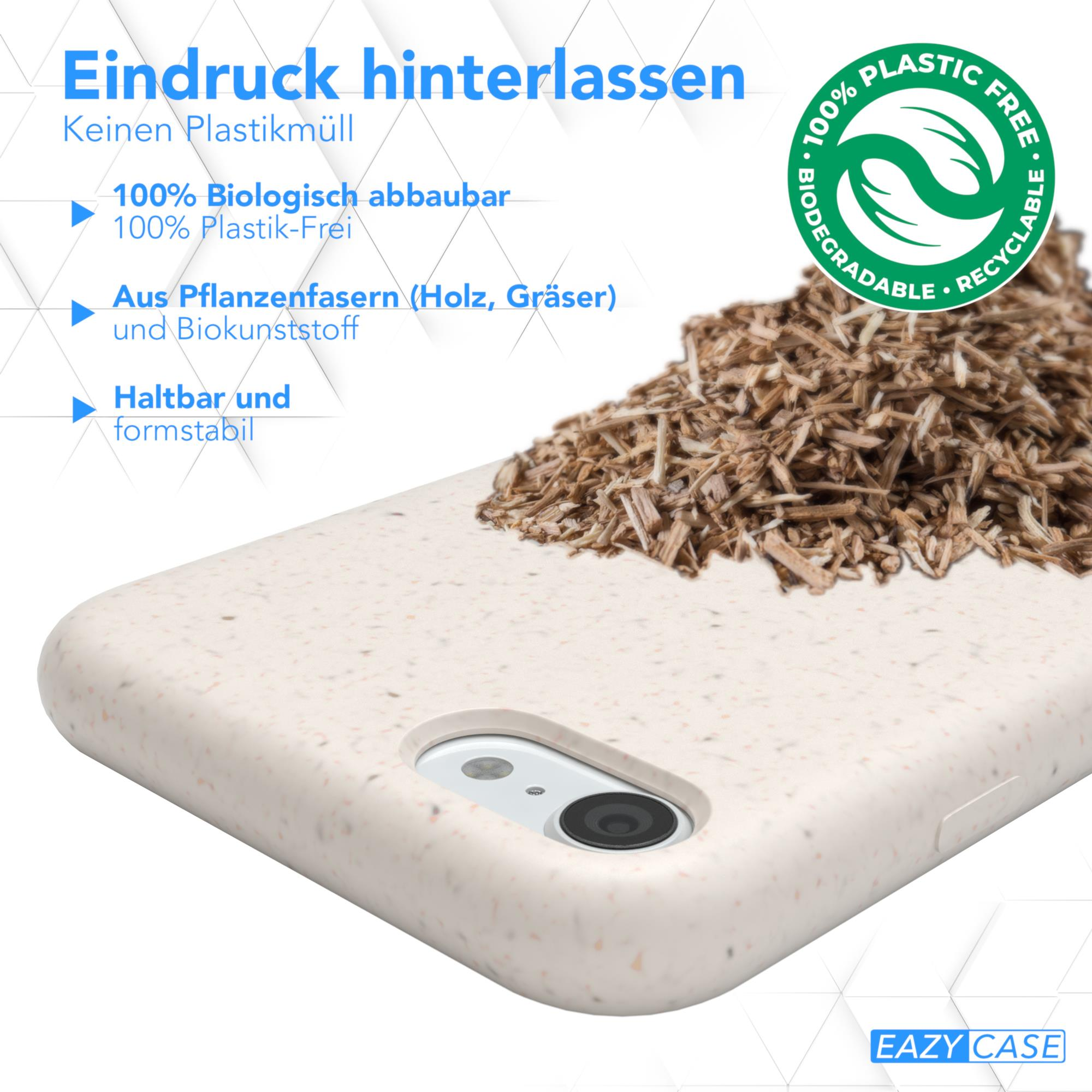 Eine Telefonhülle aus Pflanzenfasern mit einem Telefon darin und einem Haufen Holzhackschnitzel.