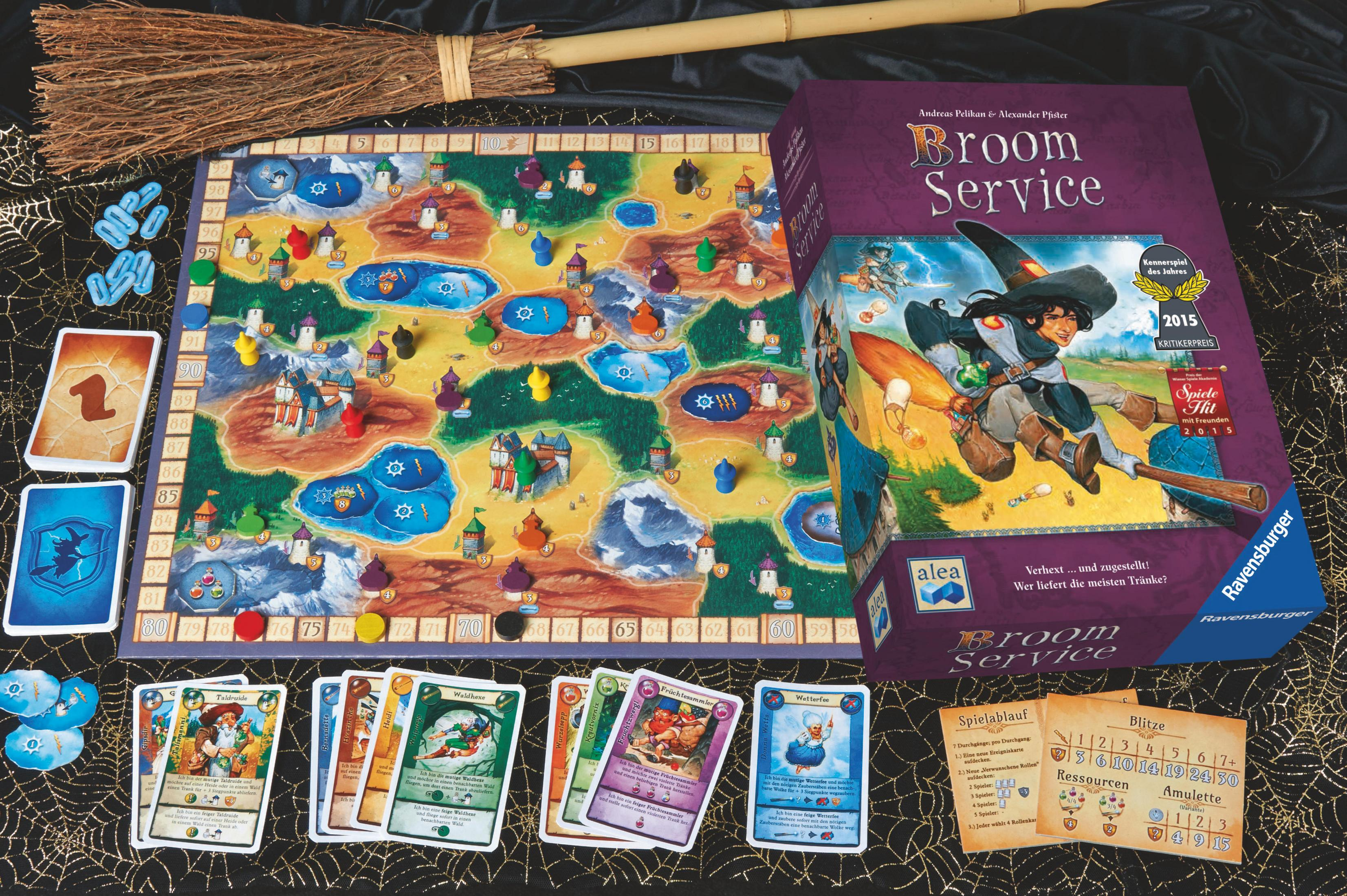Ein Brettspiel-Setup mit Karten, Spielsteinen und einer Box mit einem Hexen-Thema.