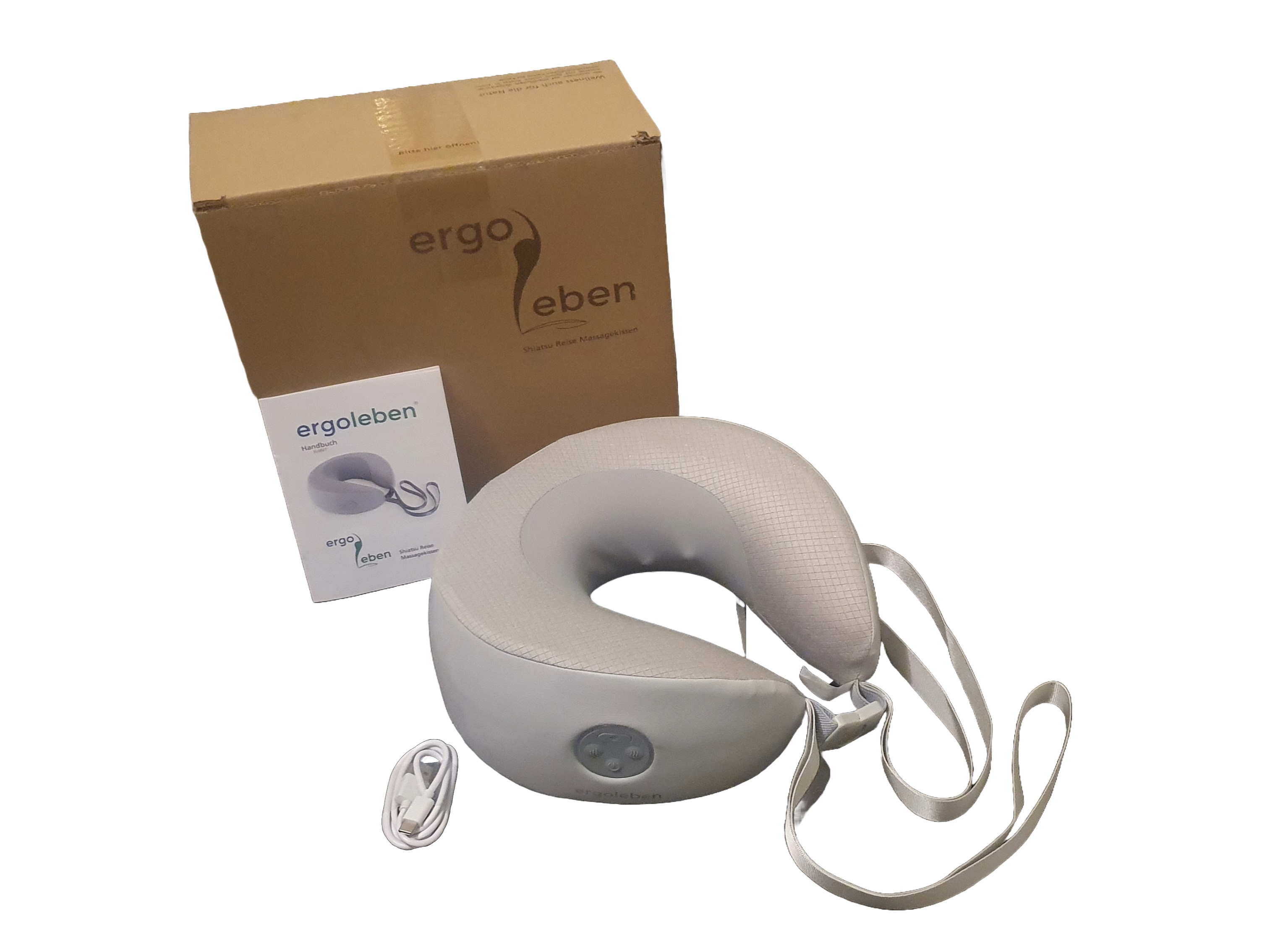 Graues Nackenkissen mit weißem Ladekabel in einem Karton. Text auf der Box: 'Ergo Eben'.