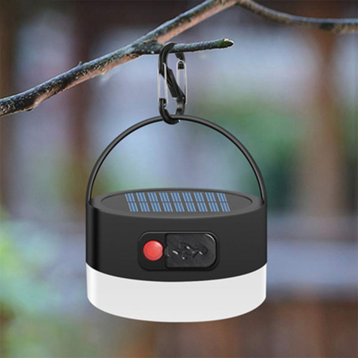 Eine schwarz-weiße Laterne, die an einem Ast hängt. Sie hat einen roten Knopf und einen USB-Anschluss.