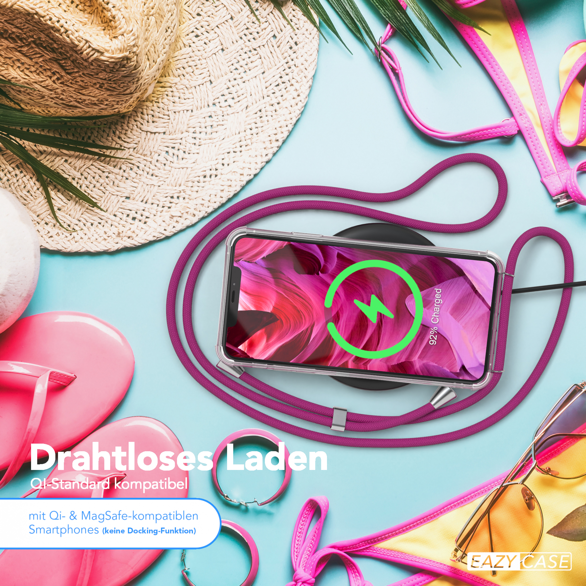Telefon lädt auf einem kabellosen Ladegerät, neben Hut, Sonnenbrille und Flip-Flops.