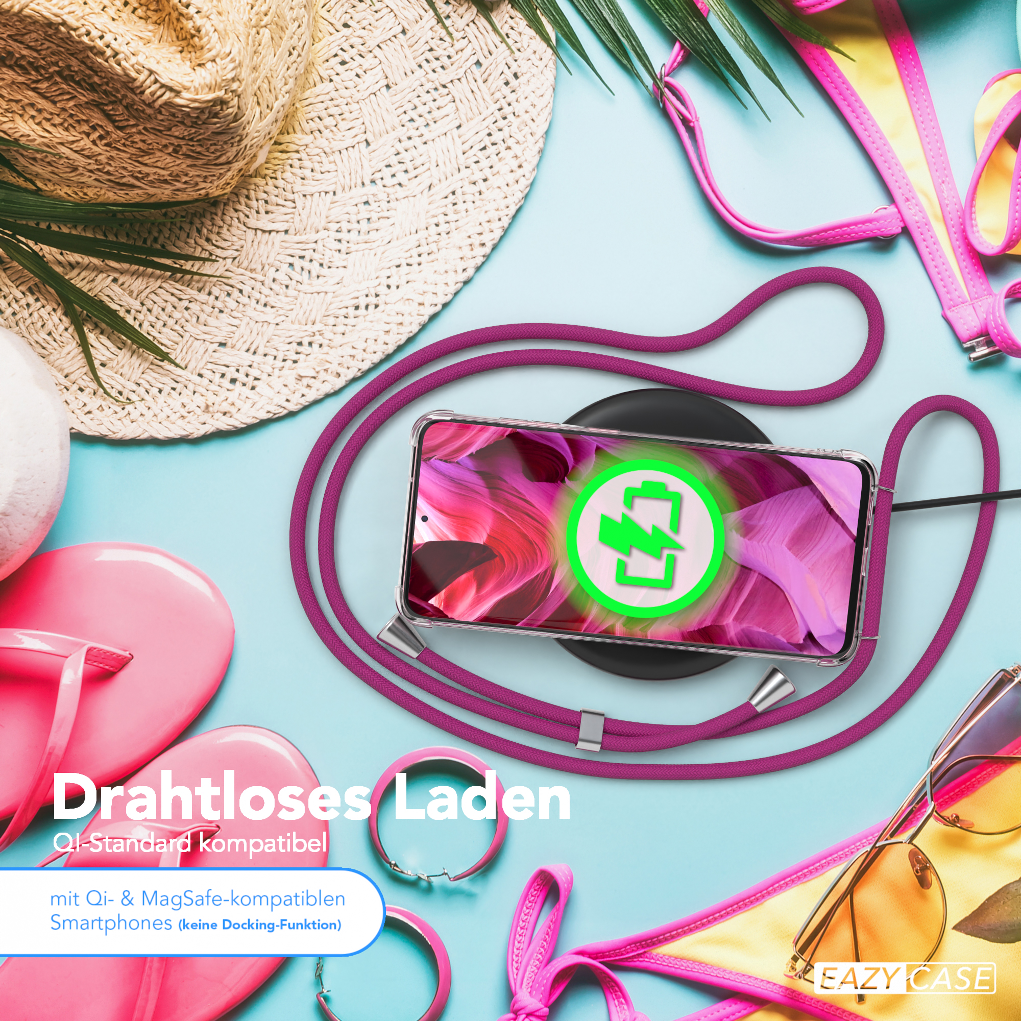 Strandszene mit Handy auf Ladepad, Sonnenbrille und Strandaccessoires.