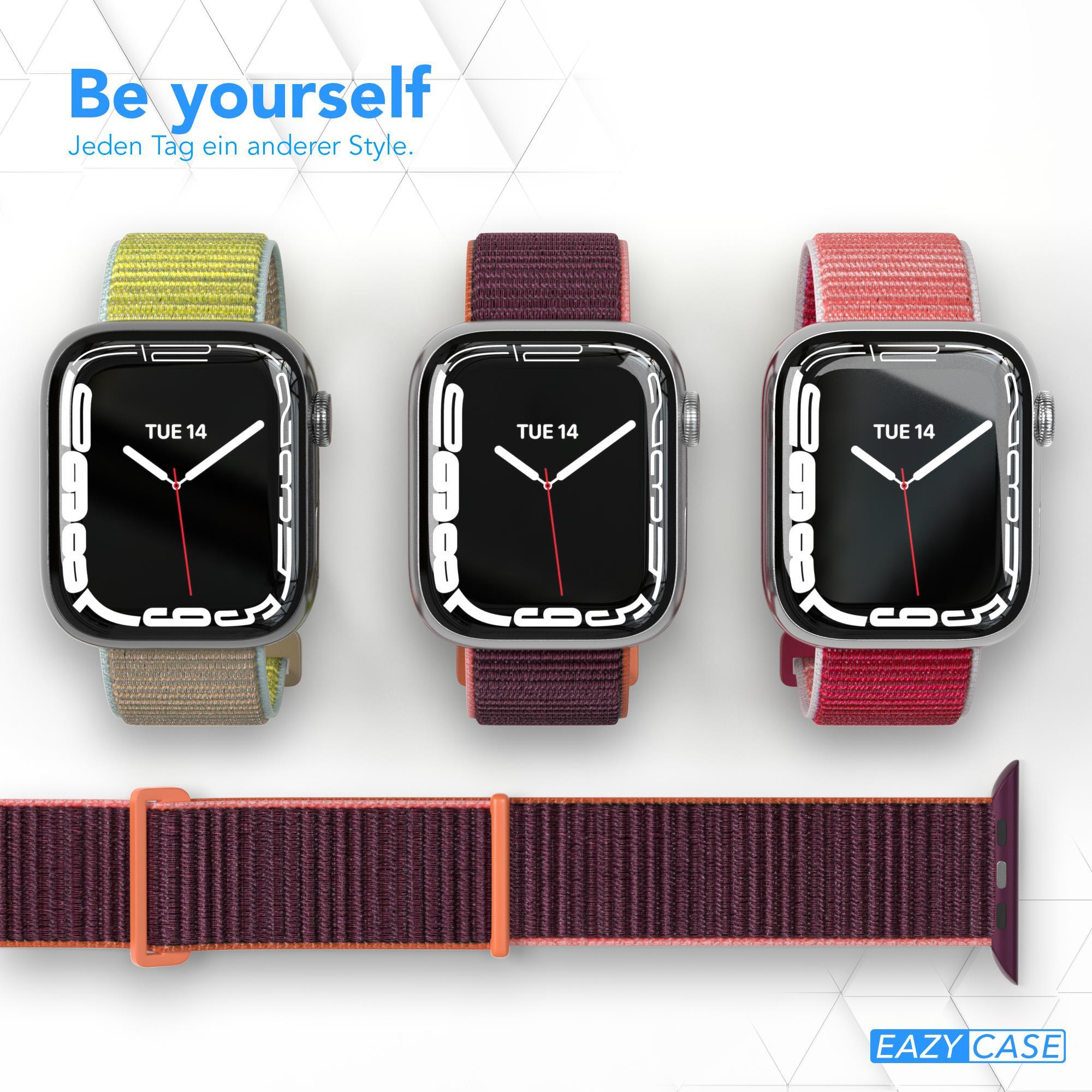 Drei Smartwatches mit verschiedenfarbigen Armbändern: grün, weinrot und rosa, plus ein weinrotes Band.
