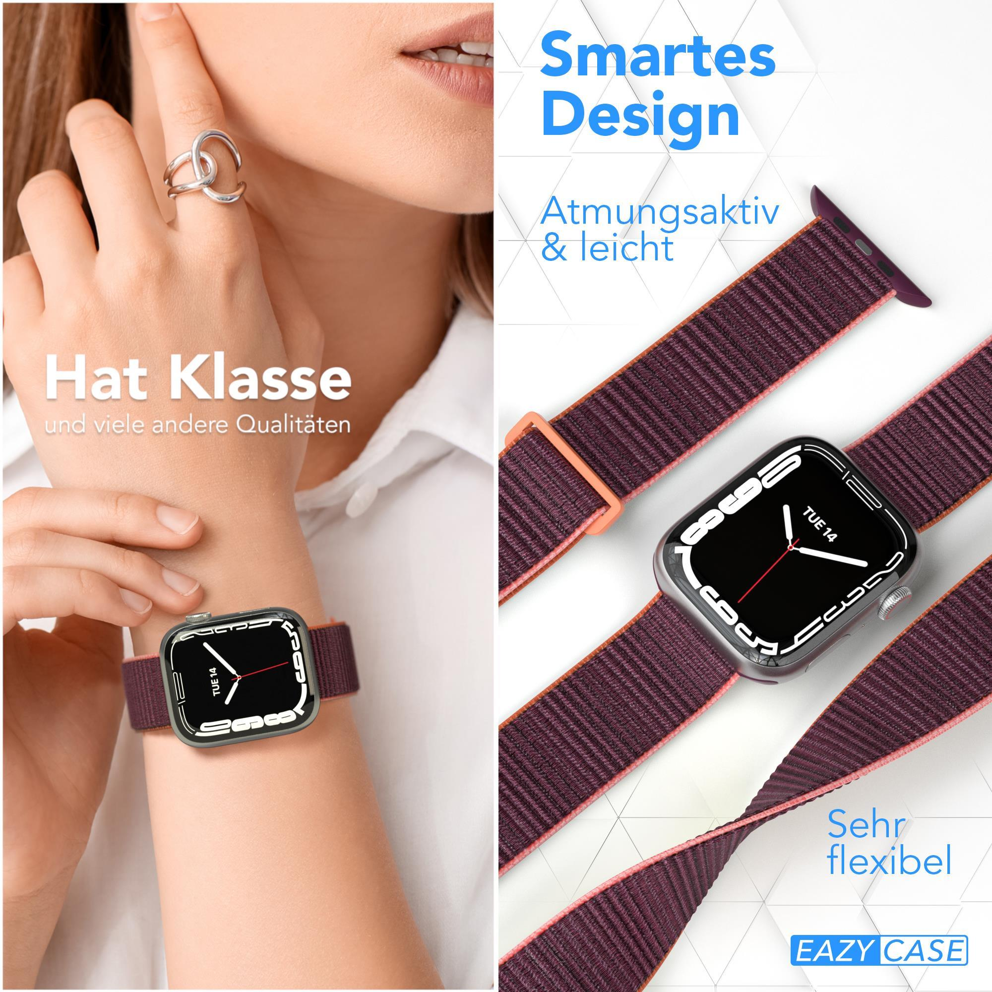 Eine Person trägt eine Uhr mit einem weinroten Armband. Die Uhr zeigt die Zeit und hat ein silbernes Gehäuse.