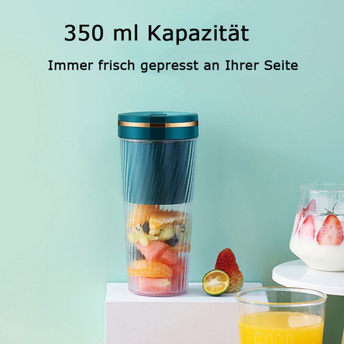 Ein kleiner Mixer mit einem türkis und transparenten Behälter, gefüllt mit Obst. Es gibt zwei Gläser mit Obst.