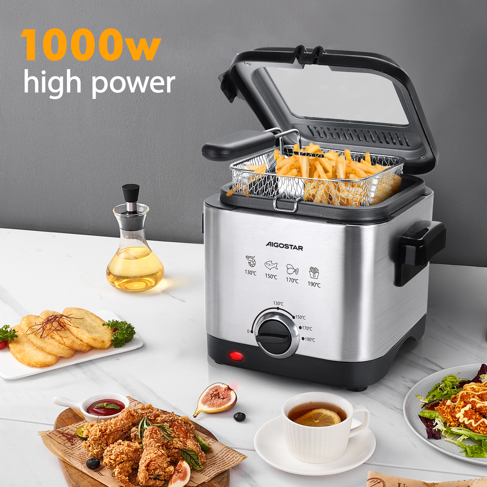 Una freidora de acero inoxidable abierta con papas fritas, rodeada de comida cocinada y condimentos.