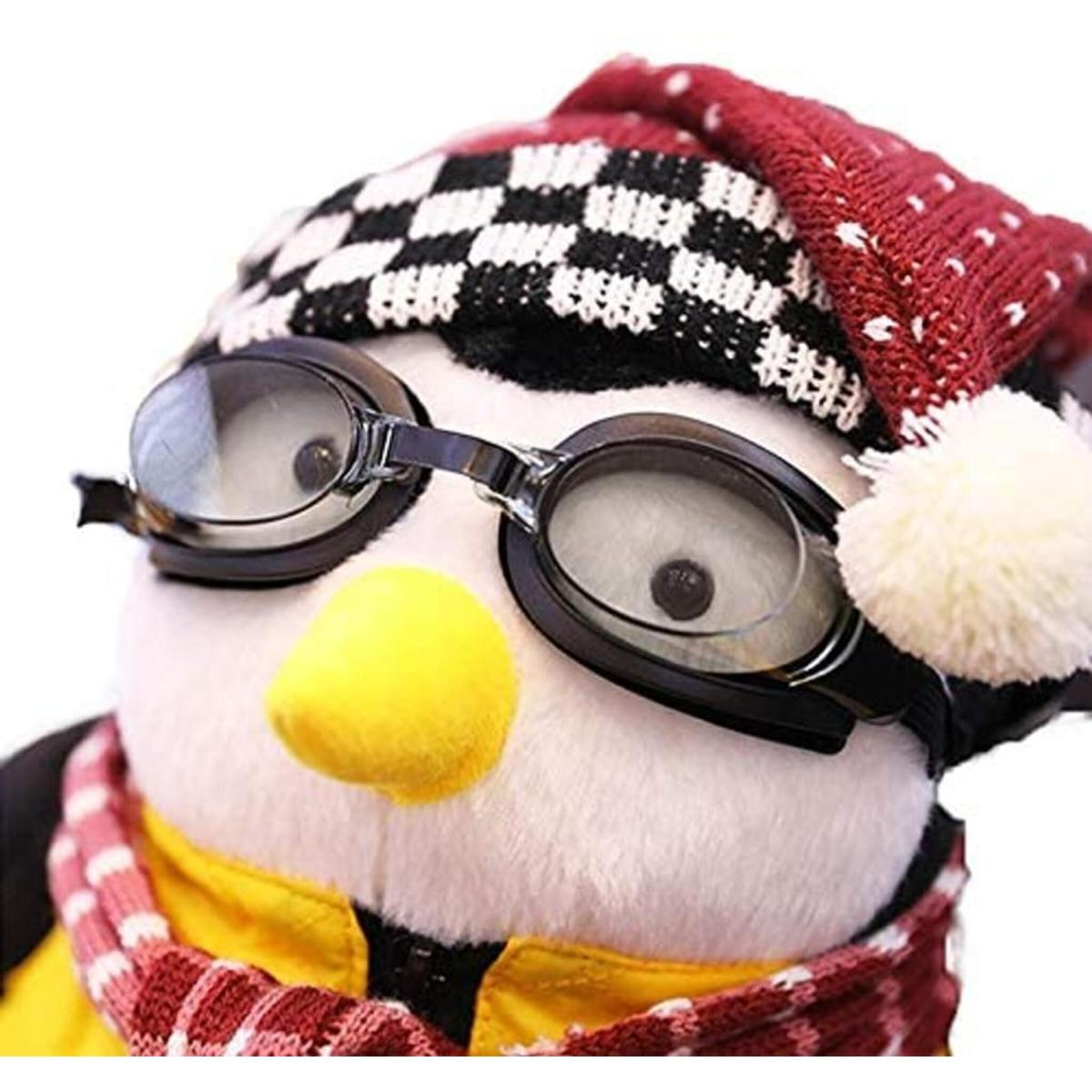 Pinguin-Plüschtier mit Brille und Hut, Nahaufnahme.