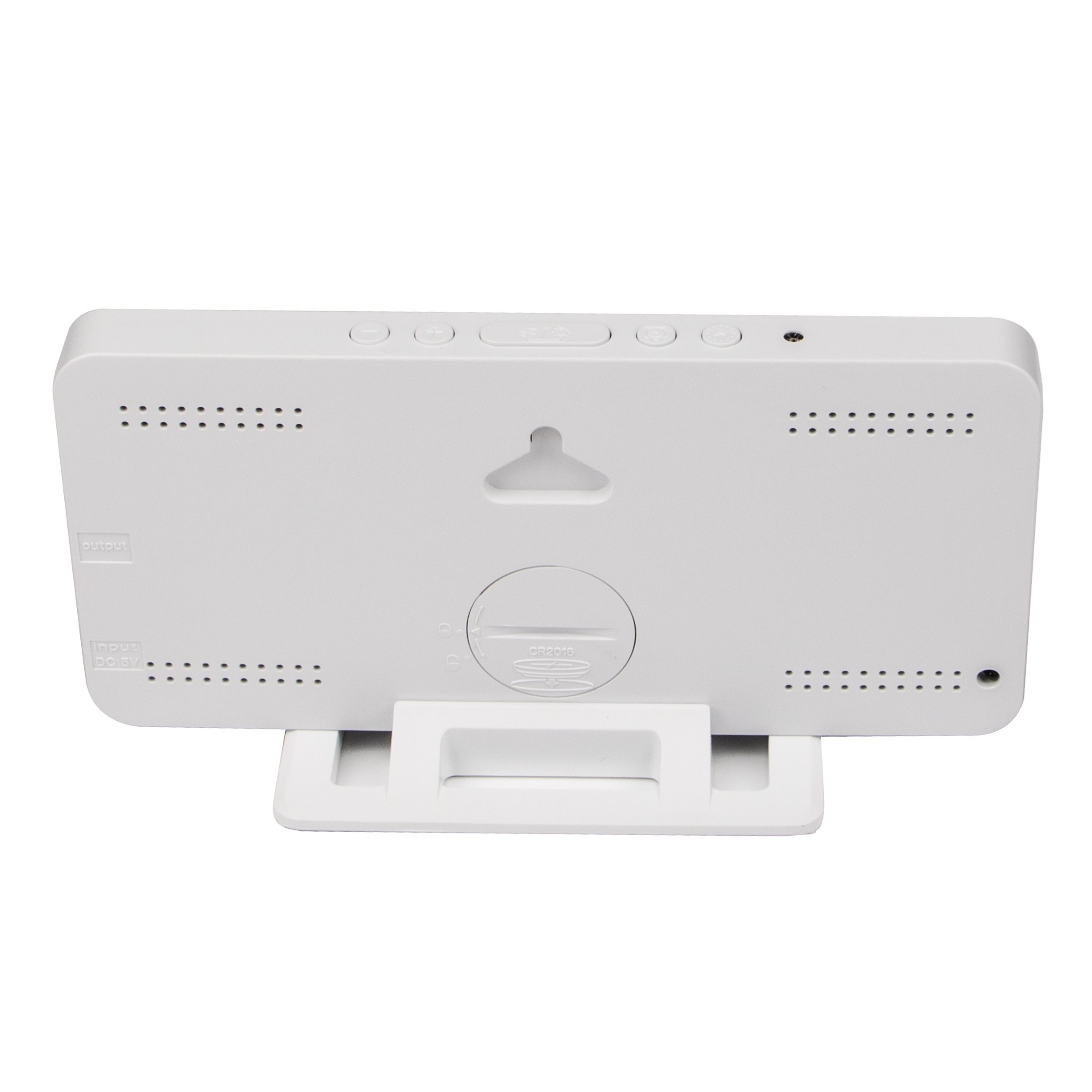 The back of a white digital clock with a stand. It has buttons and small holes for speakers.