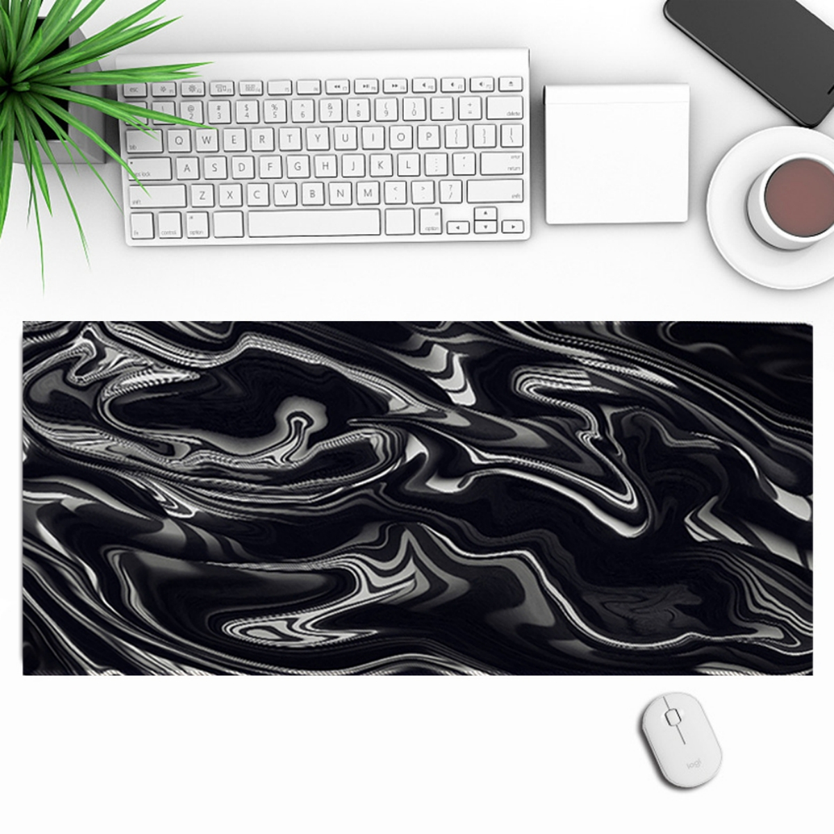 Schreibtisch: Tastatur, Maus, Kaffee, Telefon und schwarz-weiße Muster-Matte.