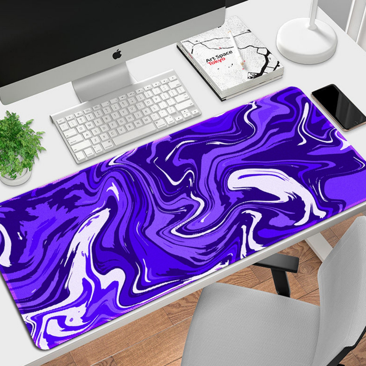 Lila Mousepad mit Marmordesign. Oben liegt eine weiße Tastatur.