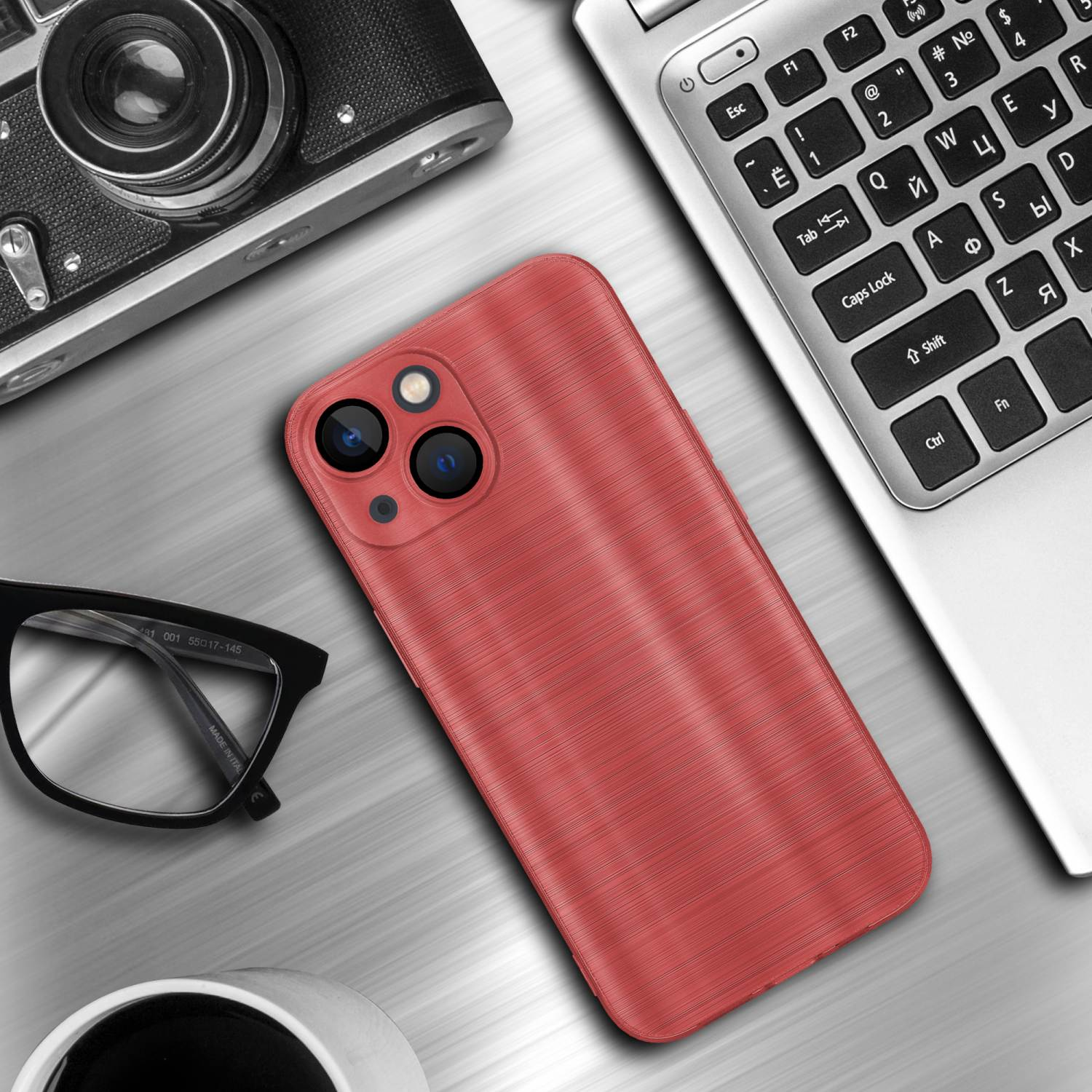 Rote Handyhülle auf einem Schreibtisch mit Laptop, Kamera und Brille. Die Hülle hat drei Kameraausschnitte.