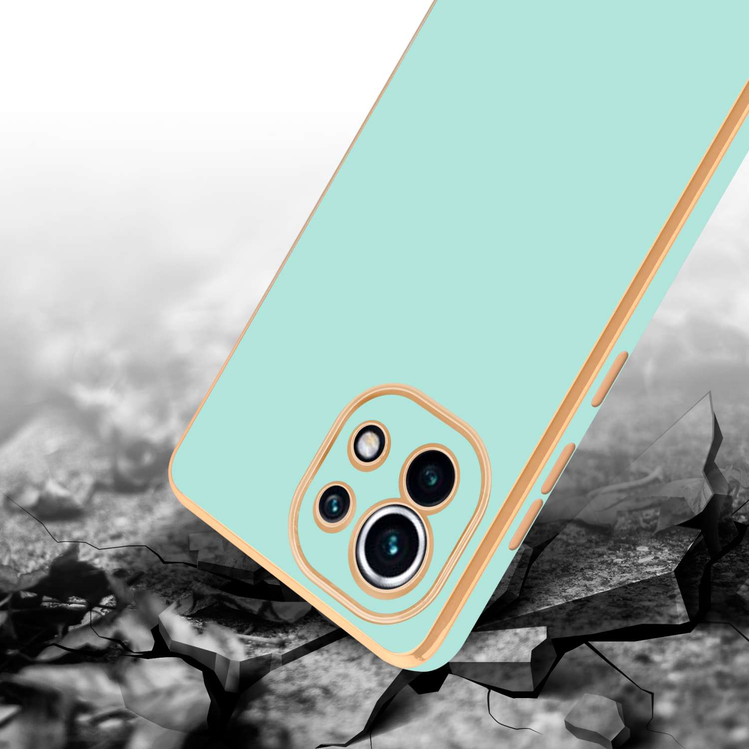 Custodia per telefono, verde menta con finiture dorate, su terreno crepato.