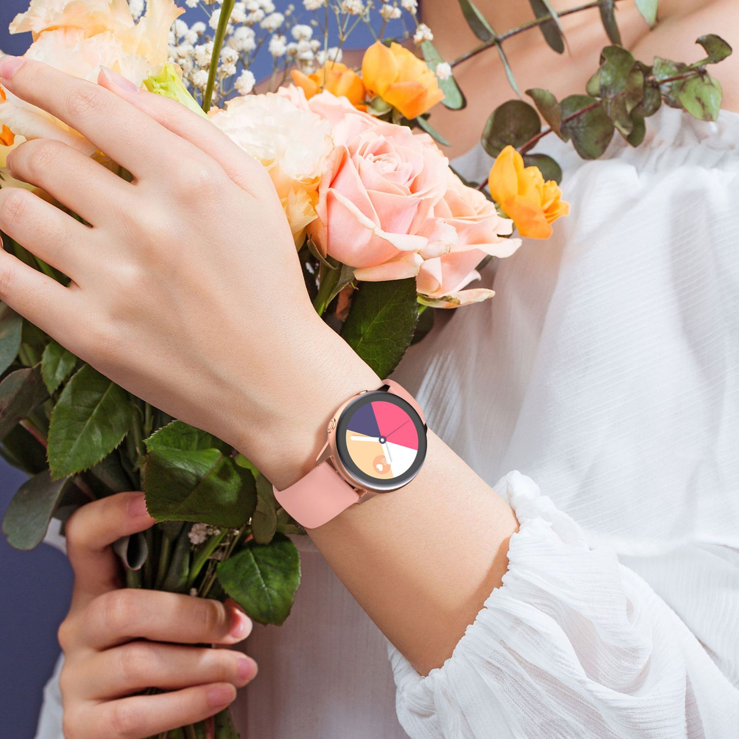Frau, die eine rosa Smartwatch trägt, während sie einen Blumenstrauß hält, auf weißem Hintergrund.