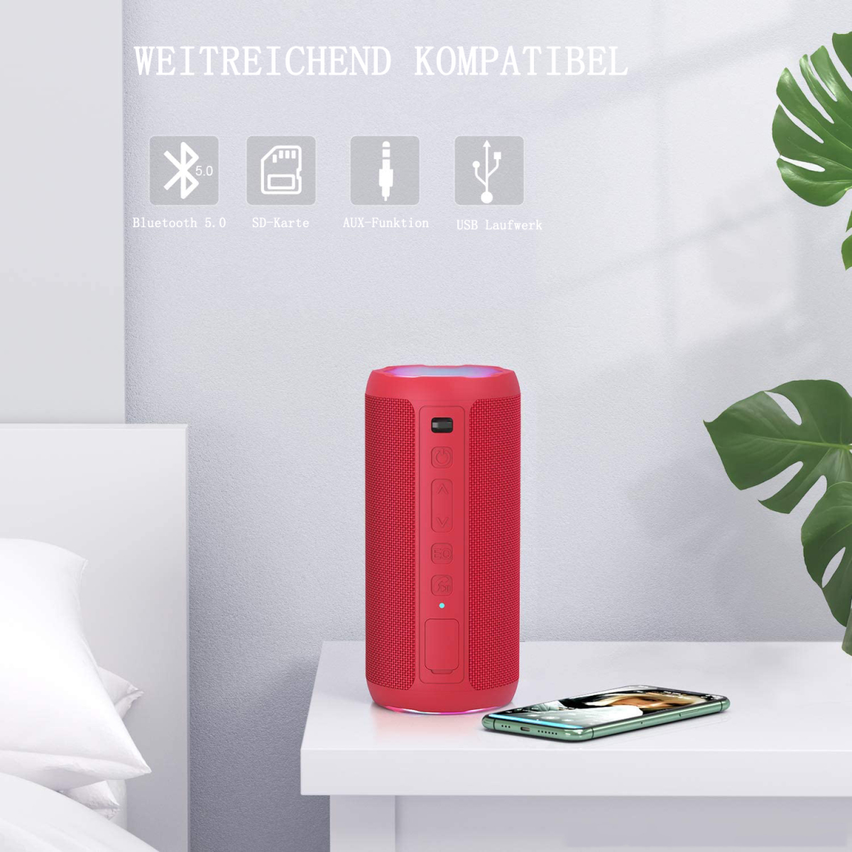 Roter Lautsprecher auf weißer Oberfläche mit Telefon darunter. Er hat Knöpfe und Symbole.